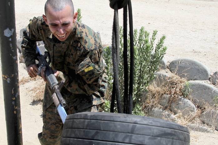 Recruits of Company H, 2nd Recruit Training Battalion, practice their bayonet slashing techniques at tire targets aboard Marine Corps Recruit Depot San Diego July 24. Recruits were given a class on how to properly carry bayonets and their various attacking techniques. After completing the bayonet assault course recruits were matched up against each other in pugil stick fights.