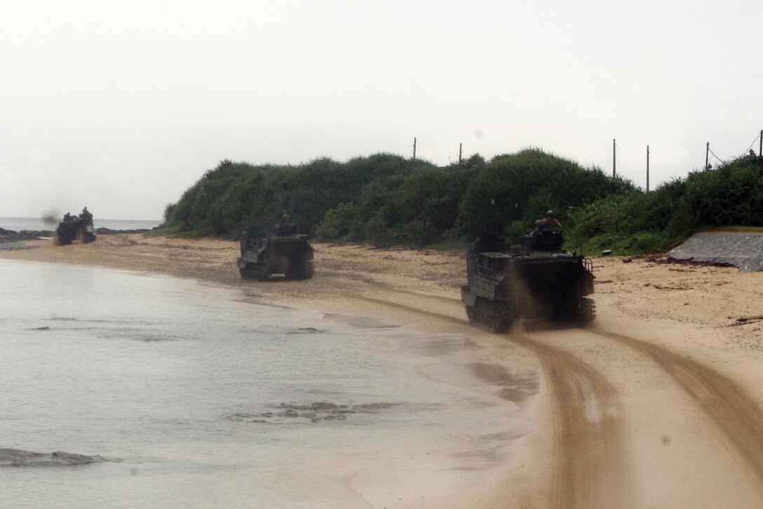 Assault amphibious vehicles of Combat Assault Battalion show their cross- country capabilities during a demonstration at Camp Schwab July 10. The AAV crewmen demonstrated the capabilities to members of the Japan Ground Self-Defense Force who took part in the Japan Observer Exchange Program. CAB is part of 3rd Marine Division, III Marine Expeditionary Force. 
