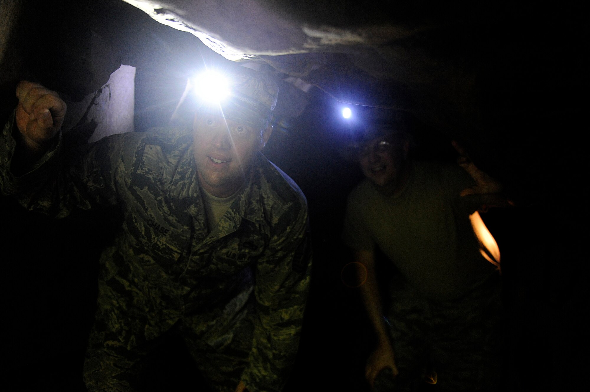 U.S. Air Force Master Sgt. Rusty Chase, NCOIC of the 18th Component Maintenance Squadron precision measurement equipment laboratory production control, climbs through a cave as part of a tour of Iwo To, Japan, formerly known as Iwo Jima, July 26, 2012. During the Battle of Iwo Jima, Japanese forces used an interconnected network of tunnels and caves as a primary defense against the invading Americans. (U.S. Air Force photo/ Airman 1st Class Maeson L. Elleman)