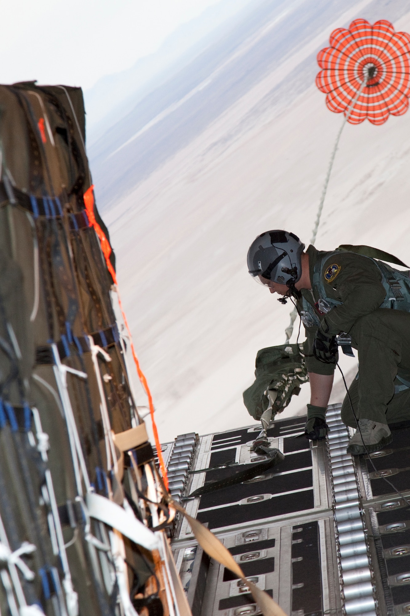 Tech. Sgt. Christopher Jones, 418th Flight Test Squadron C-130J flight test loadmaster, evaluates the cargo area July 13 during a high speed container delivery system test on a C-130J. The 418th FLTS and the C-130 Flight Test Team at Edwards Air Force Base, Calif., is currently testing a new airdrop method called the high speed container delivery system. This new system is designed to deliver supplies to troops on the ground from lower altitudes and higher airspeeds from a C-130J. (U.S. Air Force photo by Chris Neill)