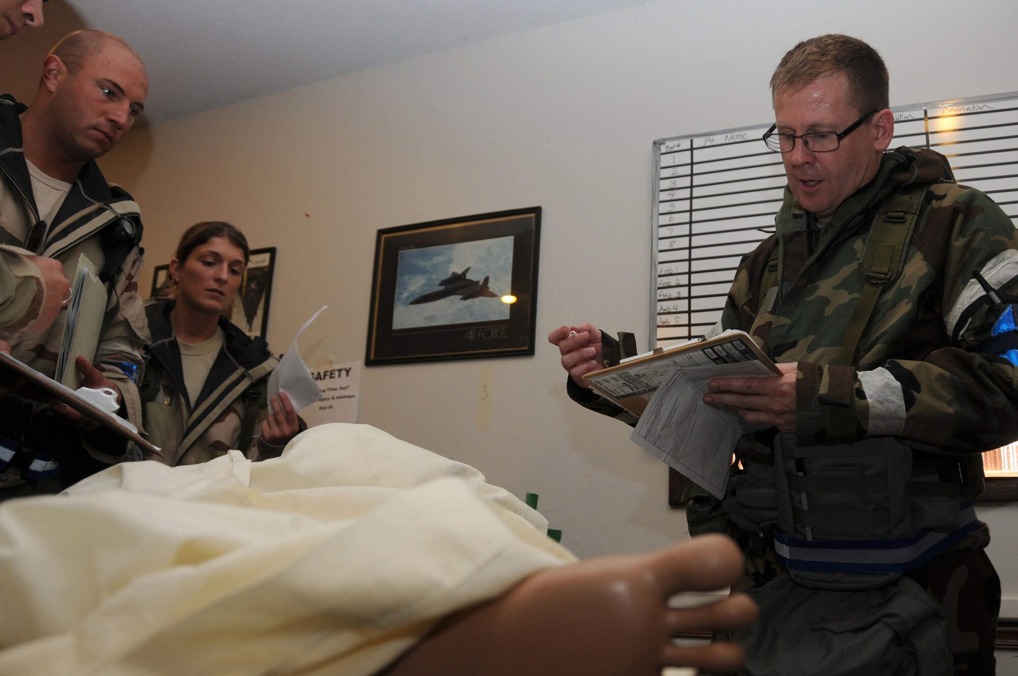ALPENA COMBAT READINESS TRAINING CENTER, Mich. – Lt. Col. Craig Miller, 125th Aeromedical Staging Squadron, performs a post surgery patient assessment during an Operational Readiness Inspection July 22, 2012.  During the assessment Lt. Col. Miller checks the patient’s vitals, injury site and ensures patient is stable for an air evacuation.  (U.S. Air Force photo by Senior Airman Jessica Mae Snow)