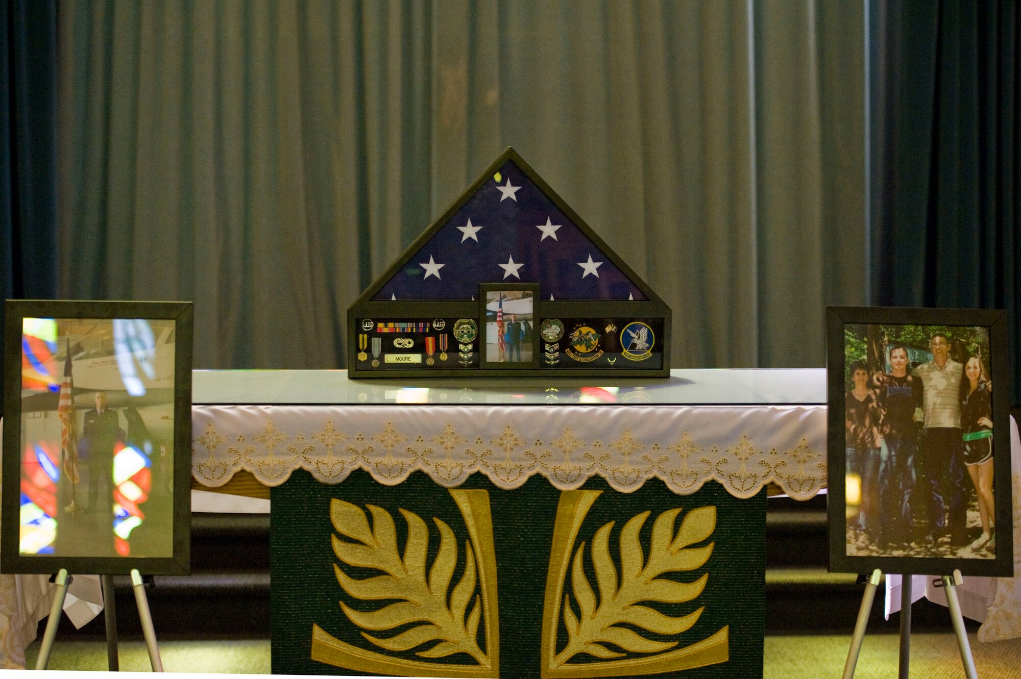 A memorial altar is displayed in memory of Senior Airman Derek Moore, 757th Aircraft Maintenance Squadron electrical and environmental systems journeyman, during a memorial service July 27, 2012, at Nellis Air Force Base, Nev. Moore was born on August 1, 1988 and originally from Bald Knob, Arkansas. (U.S. Air Force photo by Airman 1st Class Christopher Tam)