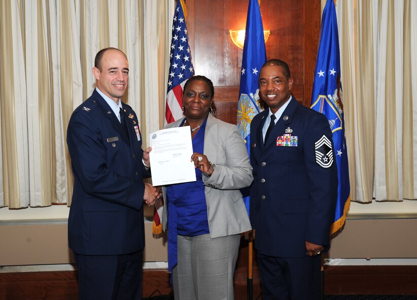 Samassa Law, AFDW Communications Directorate (A6), receives the Civilian Category III of the Quarter award from AFDW Vice Commander Col. Michael Gantt and Chief Master Sgt. Edward Harvey, AFDW Financial Management (A8) Functional Manager. The award winners were announced July 31 during a luncheon at The Club on Joint Base Andrews, Md. The quarterly winners were honored for their superior performance from April 1 through June 30, 2012. (Air Force photo by Aletha Frost)