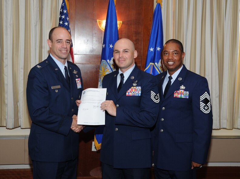 Tech. Sgt. Nathan Wallace, AFDW Contracting (PK), accepts the Noncommissioned Officer of the Quarter award from AFDW Vice Commander Col. Michael Gantt and Chief Master Sgt. Edward Harvey, AFDW Financial Management (A8) Functional Manager. The award winners were announced July 31 during a luncheon at The Club on Joint Base Andrews, Md. The quarterly winners were honored for their superior performance from April 1 through June 30, 2012. (Air Force photo by Aletha Frost)