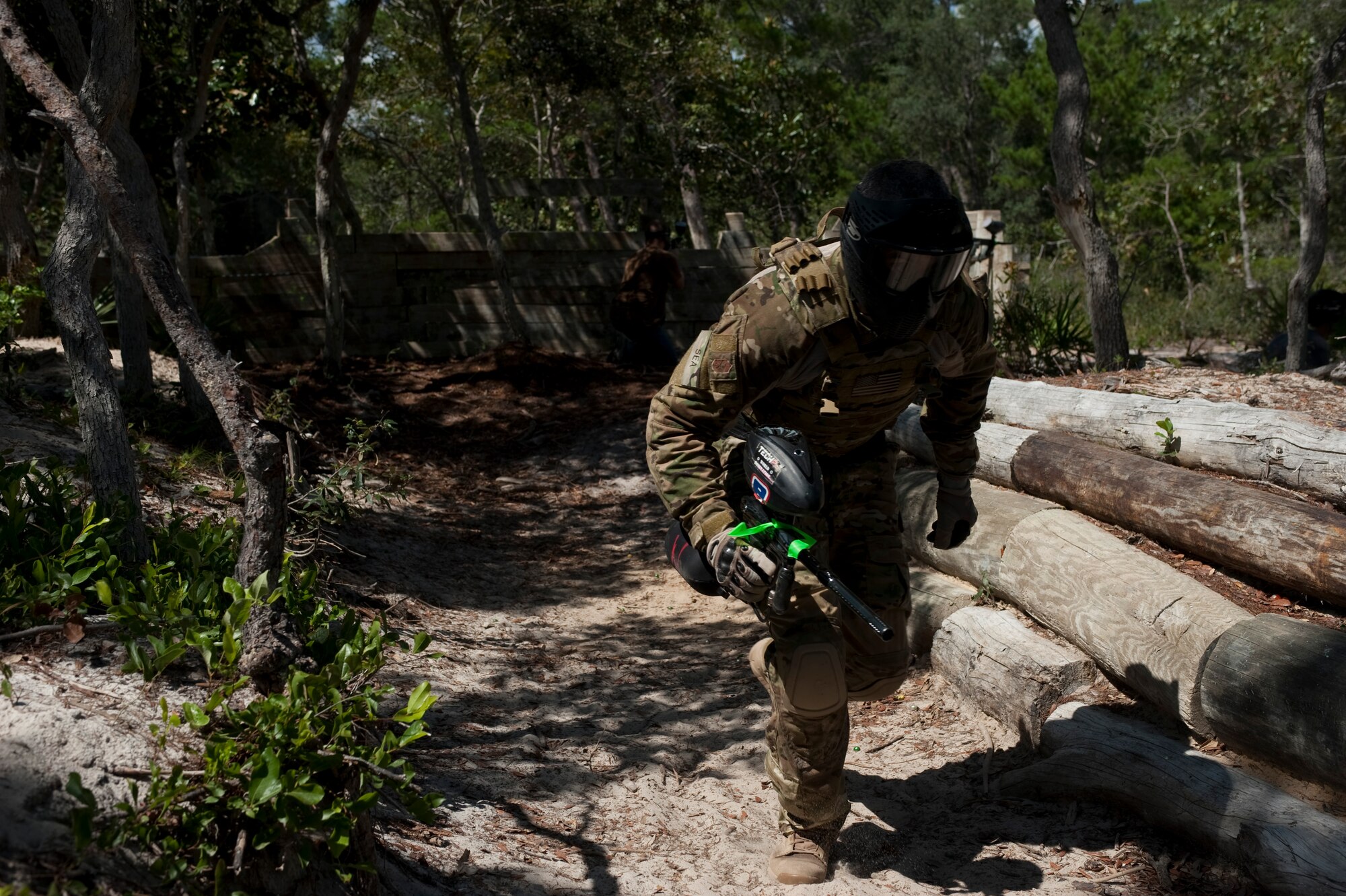 U.S. Air Force Chief Master Sgt. Ramon Colon-Lopez, command chief of 1st Special Operations Wing, runs for cover during a paintball game at the paintball field, Hurlburt Field, Fla., July 27, 2012. For Colon-Lopez, taking to the paintball field was not outside the scope of his regular workday if it meant connecting with Airmen. (U.S. Air Force Photo/Airman 1st Class Hayden K. Hyatt)