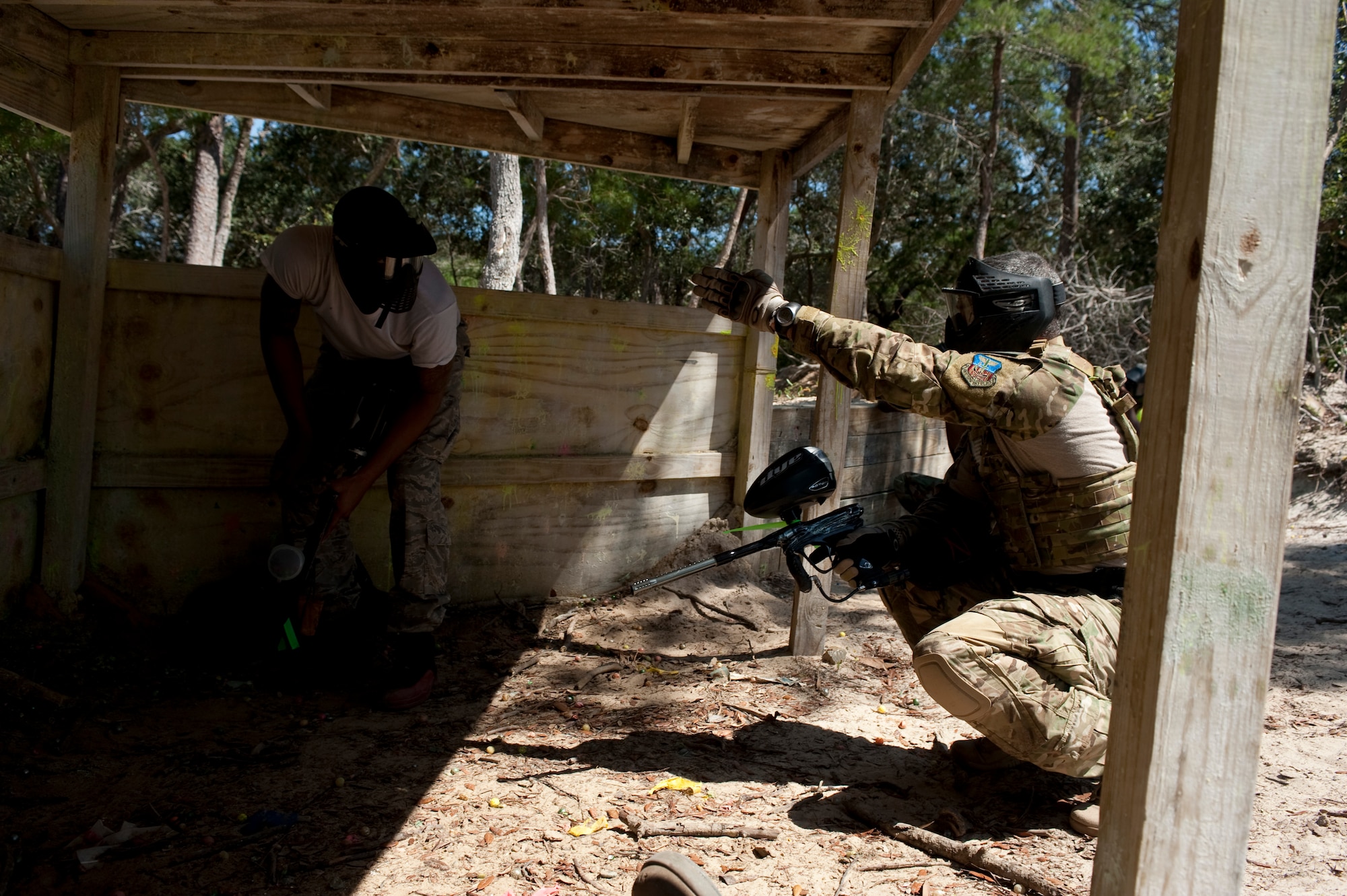 U.S. Air Force Chief Master Sgt. Ramon Colon-Lopez, command chief of 1st Special Operations Wing, relays a strategy to an Airman during a paintball game at the paintball field, Hurlburt Field, Fla., July 27, 2012. Paintball also provided a non-conventional avenue for Airmen to practice their situational awareness and other skills important to combat environments. (U.S. Air Force Photo/Airman 1st Class Hayden K. Hyatt)