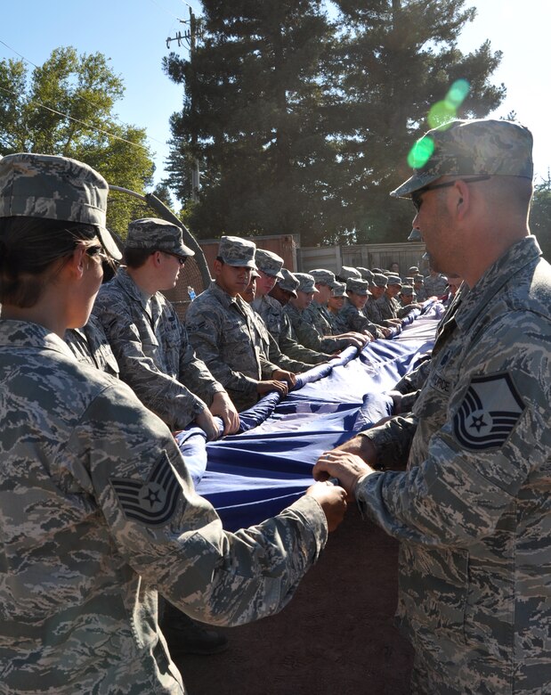 Members of Team Beale hold the American Flag during the opening ceremonies of Military Appreciation Night at a Marysville Gold Sox game at Appeal-Democrat Park, Marysville, Calif., July 29, 2012. More than 75 Airmen unfurled Old Glory during the national anthem at the start of the game. (U.S. Air Force photo by Staff Sgt. Robert M. Trujillo)