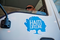 An Airman from the 22nd Logistics Readiness Squadron operates a cargo truck including supplies being sent to Haiti as part of the Haiti Lifeline Ministries relief program July 26, 2012, McConnell Air Force Base, Kan. The 22nd LRS gathered supplies including food, shoes and mattresses provided by civilians and prepared them to be shipped to Haiti on C-5 Galaxy. (U.S. Air Force photo by Airman 1st Class Victor J. Caputo)