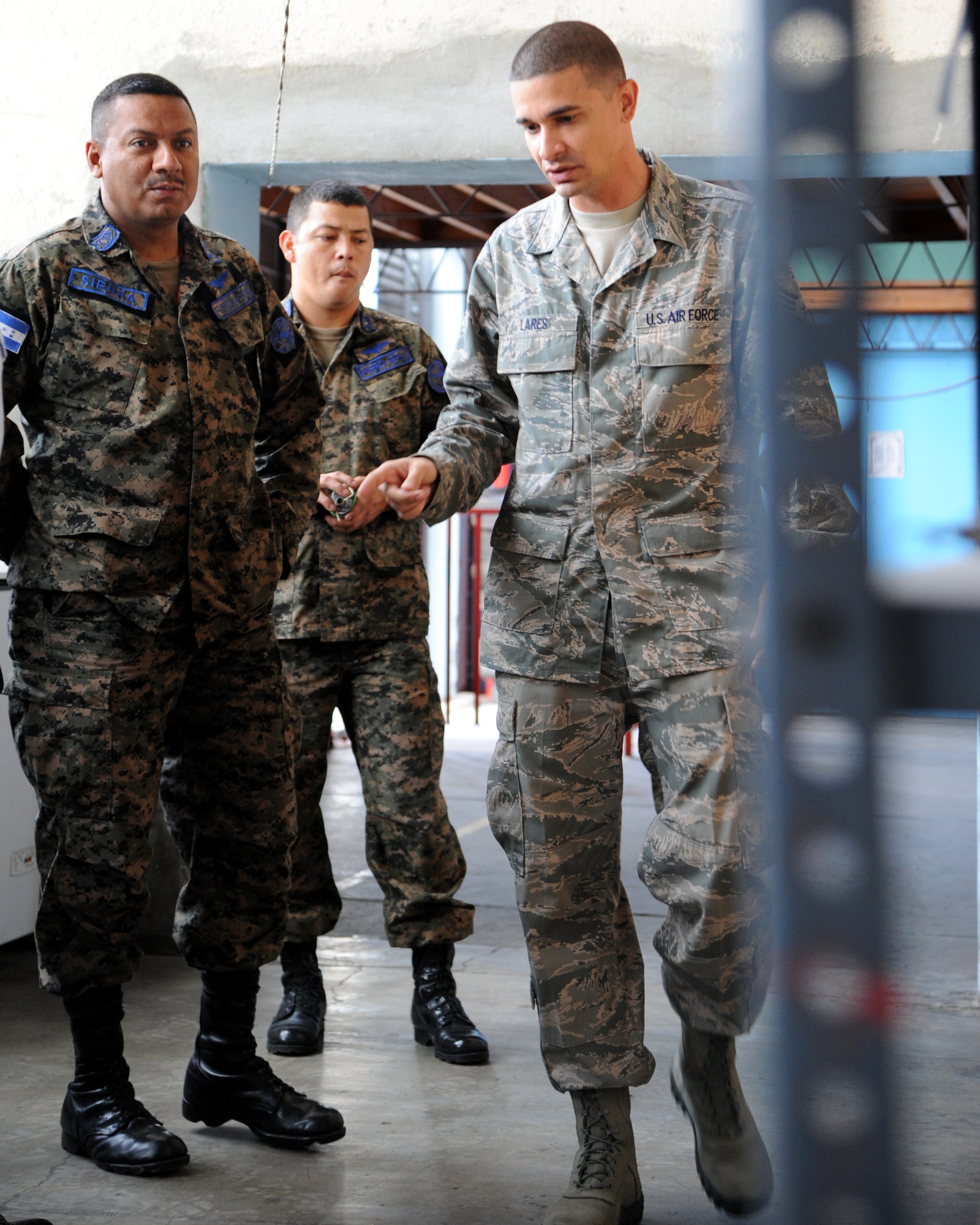 Tech. Sgt. Jason Lares, a Supply Technician with the 571st Mobility Support Advisory Squadron, works together with Second Tech. Sgt. Mario David Sierra Moncada a Honduran Supply Technician in Tegucigalpa, Honduras.  The two Airmen are exchanging ideas relating to how the U.S. Air Force and Honduran Air Force handle their supply chain process.  Over the next 30 days Lares and Sierra will continue trading ideas and experiences while working together to build relationships and partner capacity between the U.S. and Honduran air forces.  (U.S. Air Force photo/Staff Sgt. James Stewart)
