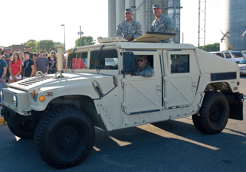 Col. Kelvin McElroy, left, commander of the 512th Maintenance Group, and Col. Thomas Reppart, commander of the 436th Mission Support Group, ride in a Humvee at the Delaware State Fair July 25, 2012, in Harrington, Del. The parade is a yearly event that typically features Team Dover members. (U.S. Air Force photo by Senior Airman Jacob Morgan)