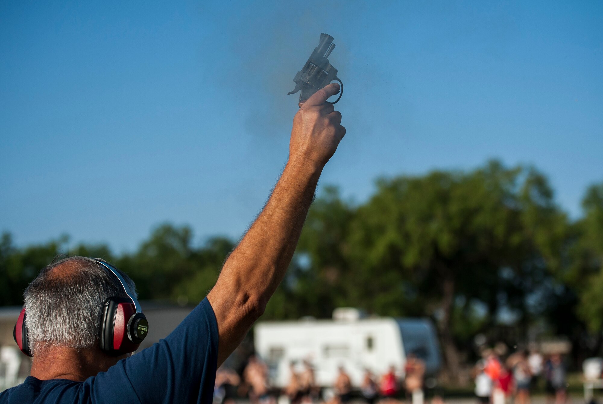GOODFELLOW AIR FORCE BASE, Texas-- Johnny Bustos, 17th Force Support Squadron, fires off the starting gun during the Goodfellow Triathlon at the Outdoor Recreation Camp July 28. The triathlon, open to military and the community, was comprised of a 400-meter swim, 20-kilometer bike ride, and a 5-kilometer run. (U.S. Air Force photo/Airman 1st Class Michael Smith)