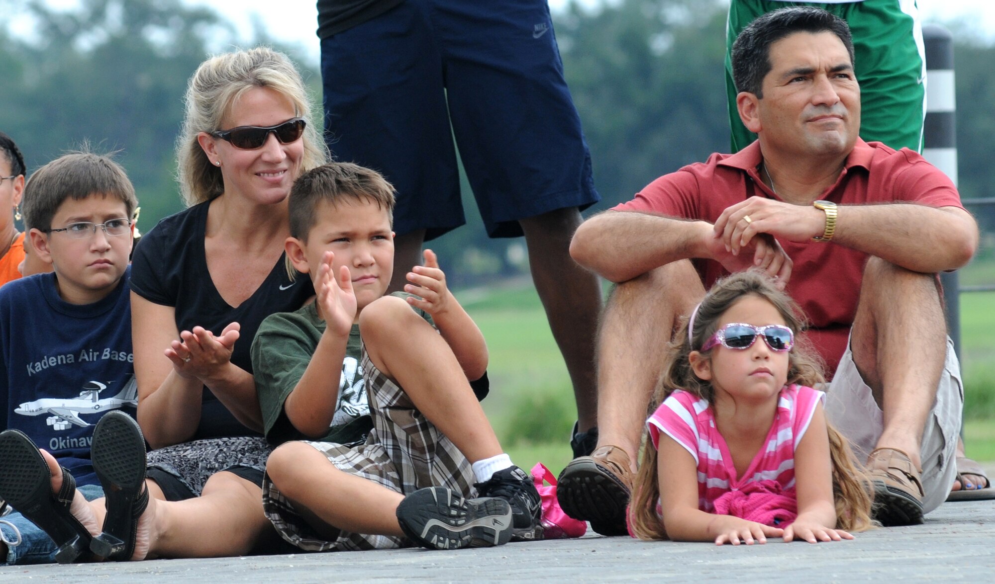 Col. Rene Romero, 81st Training Wing vice commander, right, and his family, Ben, 11, his wife, Sharmin, Matthew, 9, and Elena, 6, watch a Fata Morgana military appreciation show for Keesler families July 21, 2012, at the Bay Breeze Event Center, Keesler Air Force Base, Miss.  (U.S. Air Force photo by Kemberly Groue)