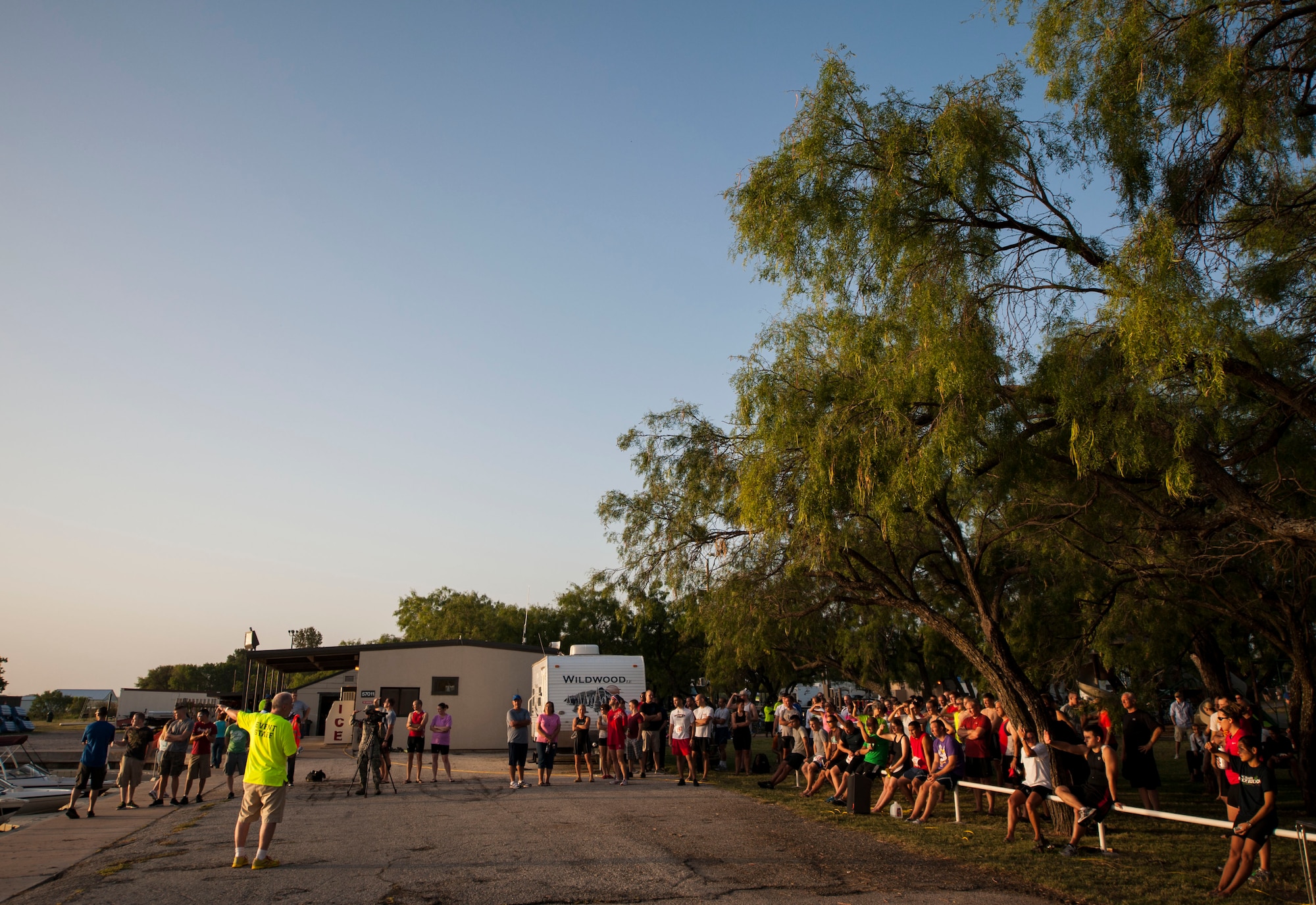 GOODFELLOW AIR FORCE BASE, Texas-- Goodfellow Triathlon participants gather before the race for a safety briefing at the Outdoor Recreation Camp July 28. The triathlon, open to military and the community, was comprised of a 400-meter swim, 20-kilometer bike ride, and a 5-kilometer run. (U.S. Air Force photo/Airman 1st Class Michael Smith)