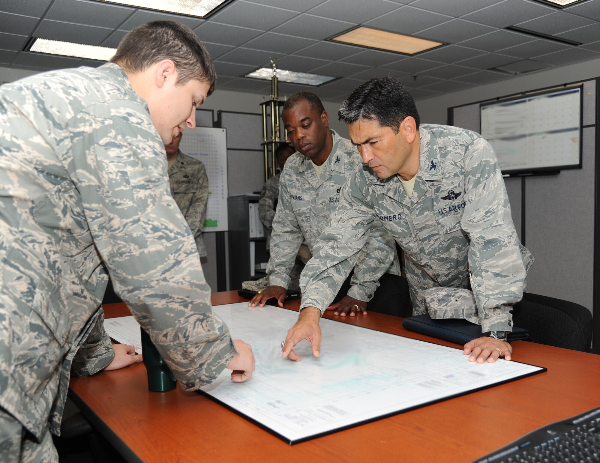 Capt. Christopher Porta, 81st Security Forces Squadron, reviews the security plan for Special Olympics’ traffic and base access with Col. Mark Vivians, 81st Mission Support Group commander and Col. Rene Romero, 81st Training Wing vice commander, during a one-day immersion tour of the 81st MSG July 24, 2012, Keesler Air Force Base, Miss.  (U.S. Air Force photo by Kemberly Groue)