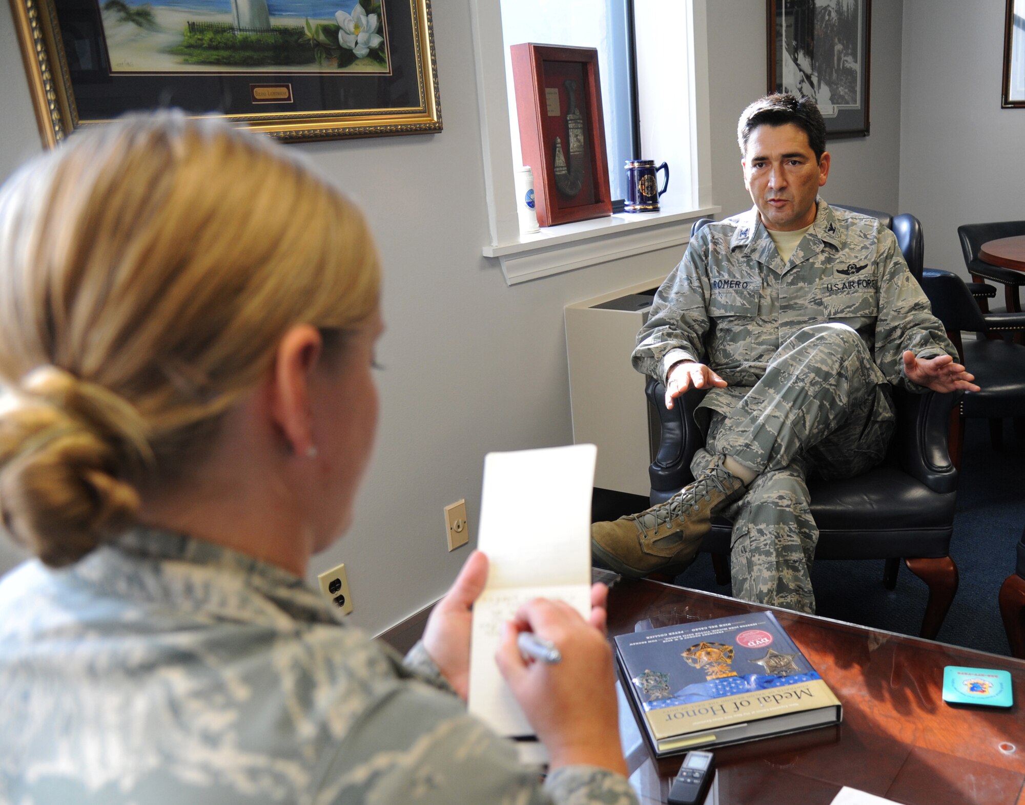 Senior Airman Heather Heiney interviews Col. Rene Romero, 81st Training Wing vice commander, for an article in the Keesler News on his arrival and expectations while at Keesler July 26, 2012, Keesler Air Force Base, Miss.  Prior to his assignment at Keesler, Romero was the Chief, Command and Control Division, Operations Directorate, Headquarters U.S. Central Command, MacDill AFB, Fla.  (U.S. Air Force photo by Kemberly Groue)