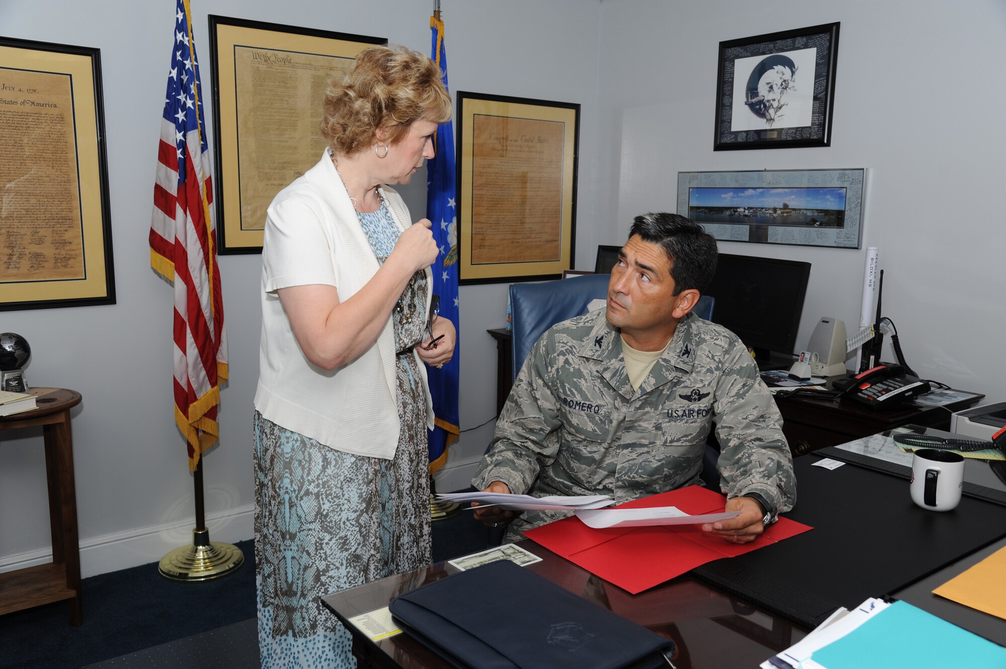 Col. Rene Romero, 81st Training Wing vice commander, is briefed on information assurance awareness security tips summary by his executive assistant, Melva Kroll, in his office July 26, 2012, Keesler Air Force Base, Miss.  Prior to his assignment at Keesler, Romero was the Chief, Command and Control Division, Operations Directorate, Headquarters U.S. Central Command, MacDill AFB, Fla.  (U.S. Air Force photo by Kemberly Groue)