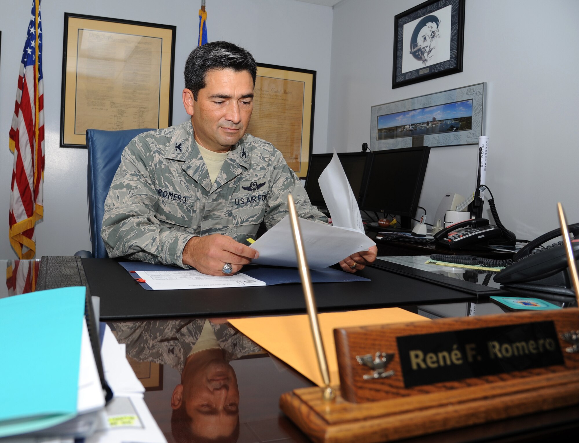 Col. Rene Romero, 81st Training Wing vice commander, reviews information assurance awareness security tips summary in his office July 26, 2012, Keesler Air Force Base, Miss.  Romero comes to Keesler from his position as the chief of the operations directorate command and control division for the U.S. Central Command headquarters at MacDill Air Force Base, Fla. He has been stationed around the United States and overseas including bases in Iceland and Japan.  (U.S. Air Force photo by Kemberly Groue)
