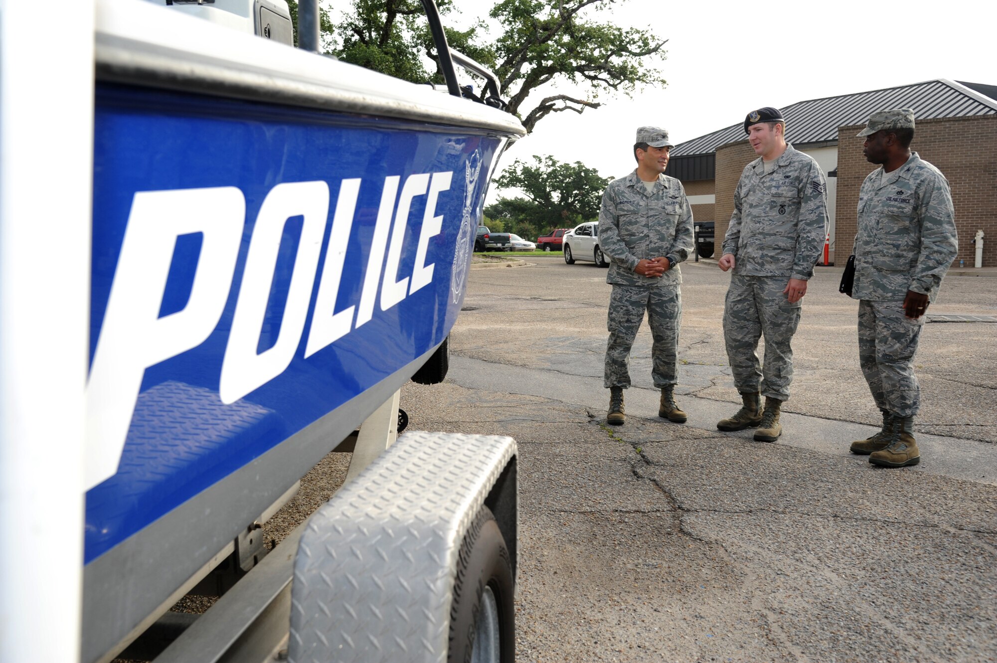 Col. Rene Romero, 81st Training Wing vice commander, left, and Col. Mark Vivians, 81st Mission Support Group commander, right, are briefed on the 81st Security Forces Squadron’s police boat, by Staff Sgt. John Rice, 81st SFS, during a one-day immersion tour of the 81st MSG, July 24, 2012, Keesler Air Force Base, Miss.  (U.S. Air Force photo by Kemberly Groue)