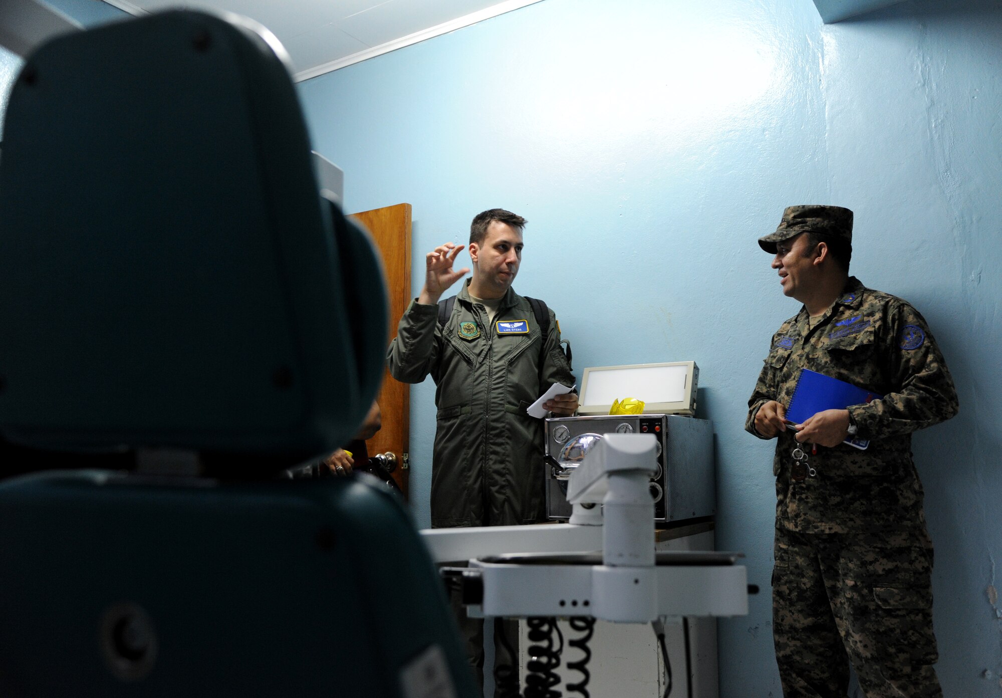 Maj. Luis Otero, a flight surgeon with the 60th Medical Operations Group discusses the dental equipment used in the clinic with a Honduran officer at Acosta Mejia Air Force Base, Tegucigalpa, Honduras on July 17, 2012.  Over the next 30 days Otero will meet with many Honduran clinic administrators to trade ideas and experiences to help each other as part of efforts to build partner capacity in between the U.S. and Honduran air forces.  (U.S. Air Force photo/Staff Sgt. James Stewart)