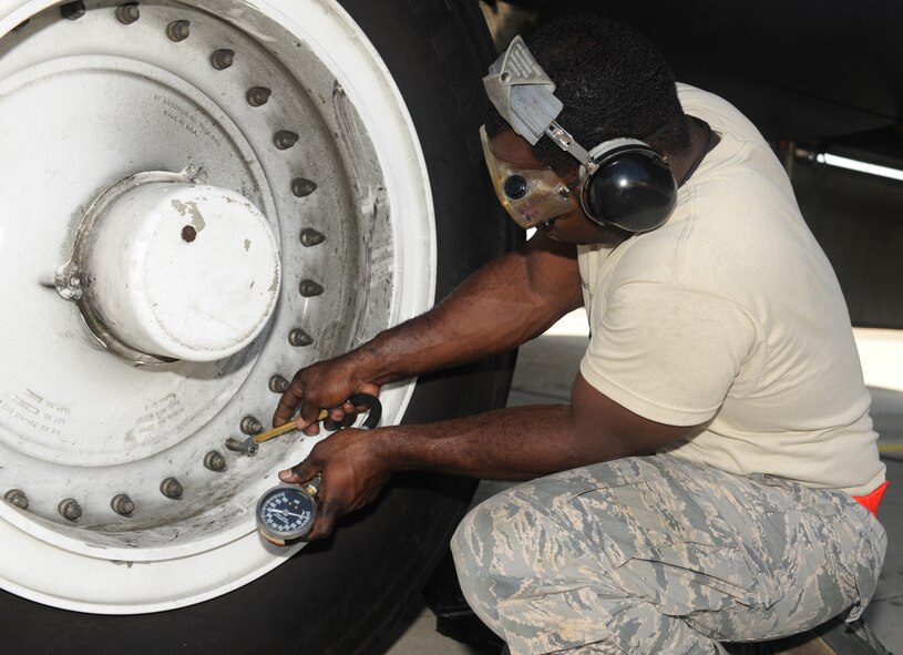 Airman 1st Class Keith Jackson, 707th Aircraft Maintenance Squadron, checks the pressure of a tire on a B-52H Stratofortress on Barksdale Air Force Base, La., July 31. The ideal pressure in psi, pounds per square inch, for a B-52 tire is 265. If there is a large deviation from 265 psi, the tire would need to be serviced, either by having air taken out or put in. The 707 AMXS is a reserve unit attached to the 307th Bomb Wing. (U.S. Air Force photo/Airman 1st Class Benjamin Gonsier)(RELEASED)