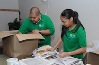 Roberto Ornelas (left), Science Technology Engineering and Math education program coordinator, and Danielle Villar, STEM senior intern, prepare the supplies needed for the Viva Technology Program Paper House Activity at St. Mary's University, San Antonio, TX. July 26. (U.S. Air Force photo by Rich McFadden) 