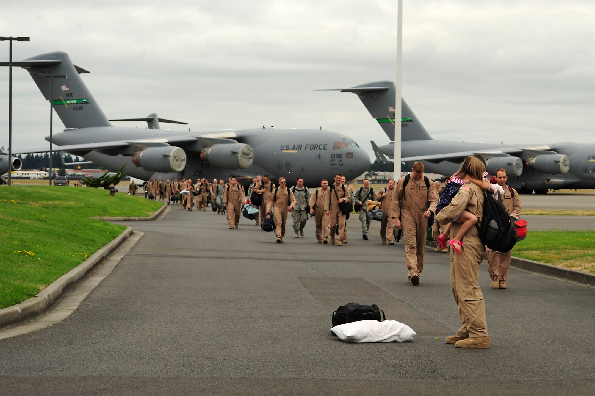 Airmen of the 8th Airlift Squadron return home July 30, 2012, at Joint Base Lewis-McChord, Wash. The Airmen were deployed as the 817th Expeditionary Airlift Squadron. Their mission was to provide global strategic airlift, airdrop, aeromedical evacuation and humanitarian relief, to create an air bridge for personnel, equipment and supplies throughout the assigned areas of responsibility. (U.S. Air Force photo/Adamarie Lewis-Page)