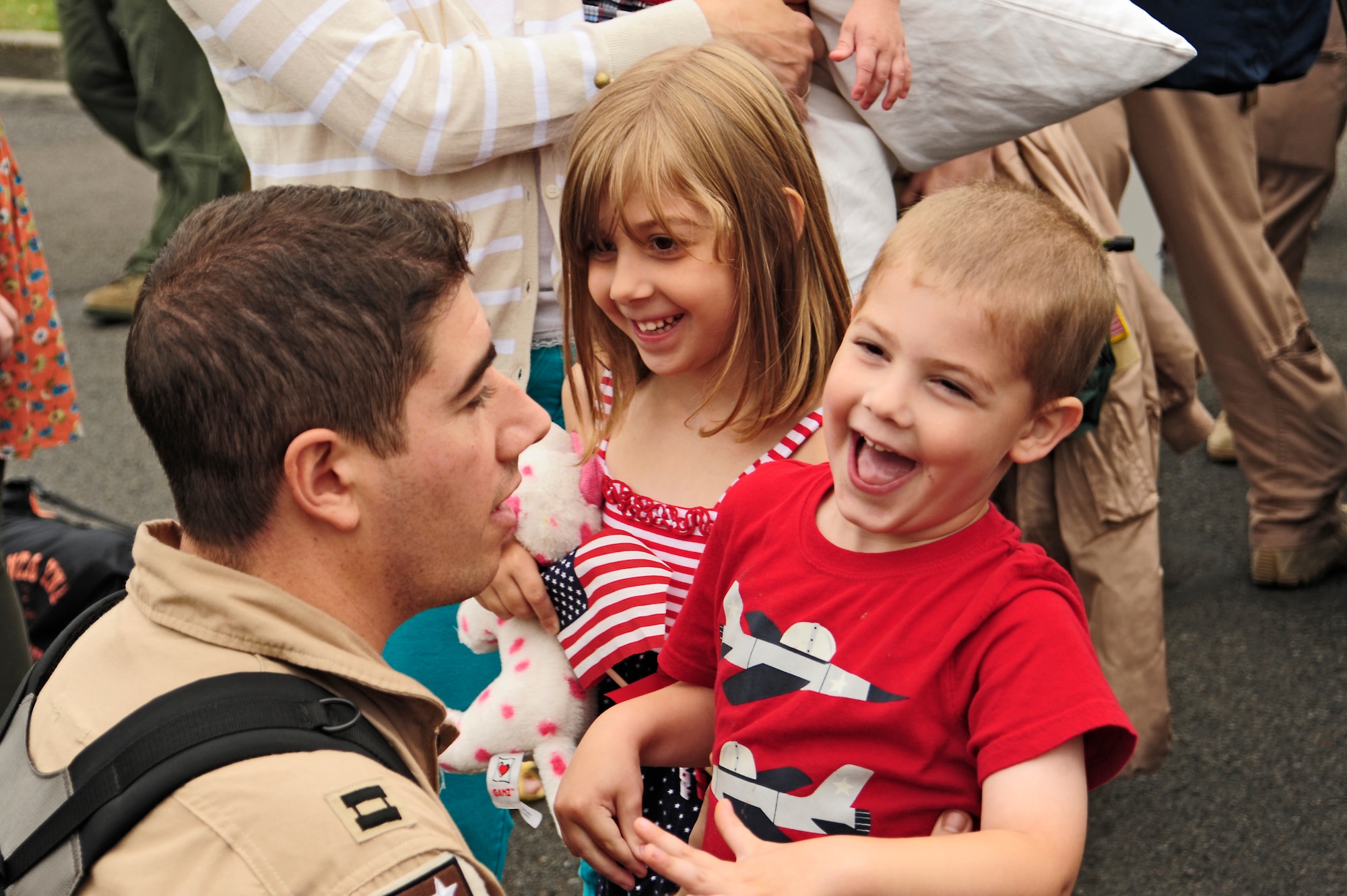 Capt. Evan Nickel, 8th Airlift Squadron pilot, greets his children, Eliana and Ezekiel, after returning from a 75-day deployment July 30, 2012, at Joint Base Lewis-McChord, Wash. The 8th AS was deployed in support of Operation Enduring Freedom. (U.S. Air Force photo/Adamarie Lewis-Page)