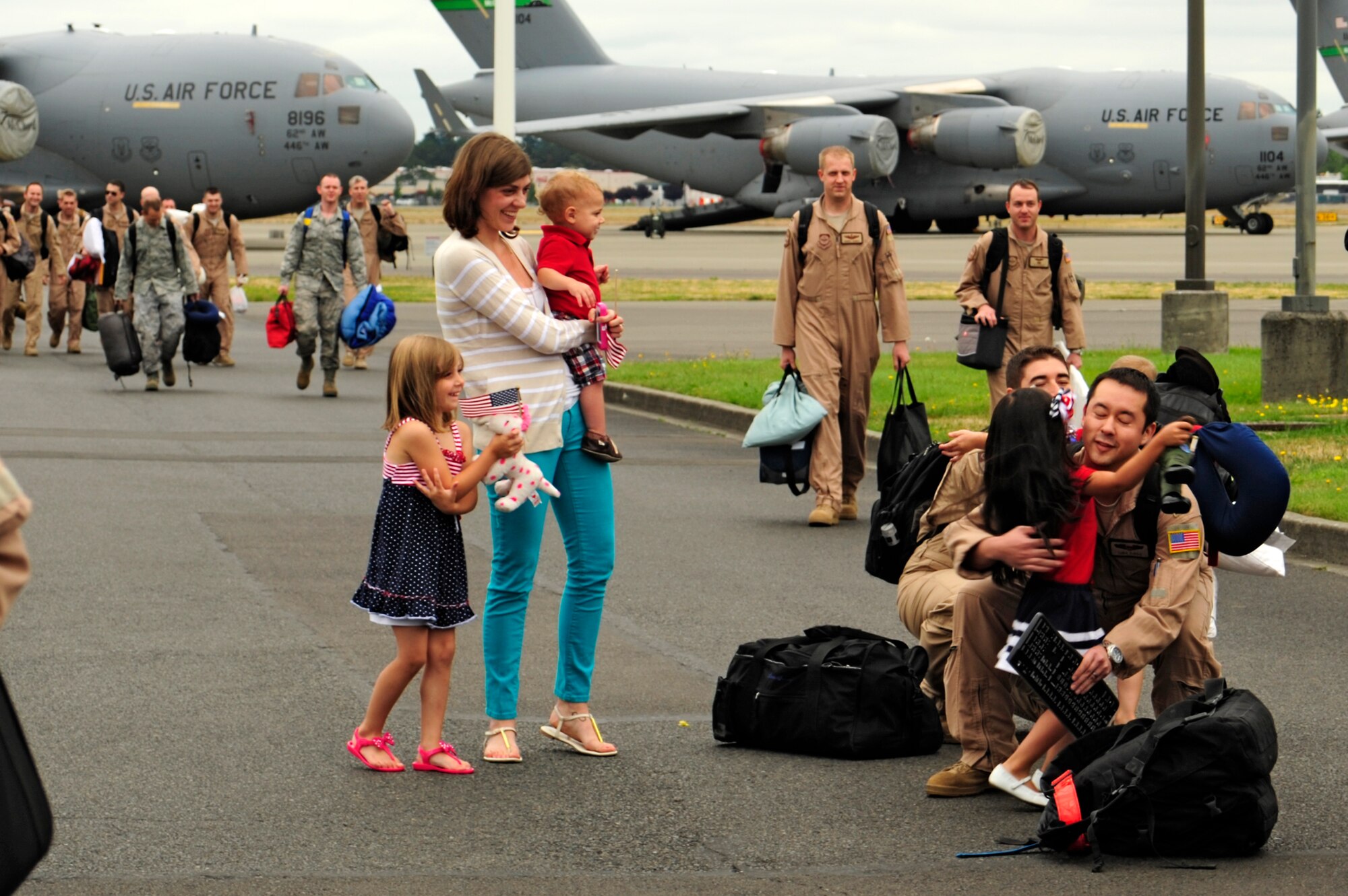 Airmen of the 8th Airlift Squadron greet their family members after returning from a 75-day deployment July 30, 2012, at Joint Base Lewis-McChord, Wash. The Airmen were deployed as the 817th Expeditionary Airlift Squadron. (U.S. Air Force photo/Adamarie Lewis-Page)