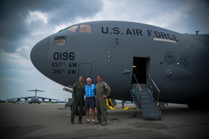 Chief Master Sgt. Damian Fox, 16th Airlift Squadron, 437th Airlift Wing operations group superintendent, poses for a photo with his father, Ronald Fox, ret. Chief Master Sgt., and his brother, Tech. Sgt. Fred Fox, 317th Airlift Squadron, 315th Airlift Wing loadmaster, after a "fini" flight July 25, 2012 at Joint Base Charleston - Air Base, S.C. Fox is a second generation chief master sergeant loadmaster who followed in his father’s footsteps. (U.S. Air Force photo by Airman 1st Class George Goslin/Released)