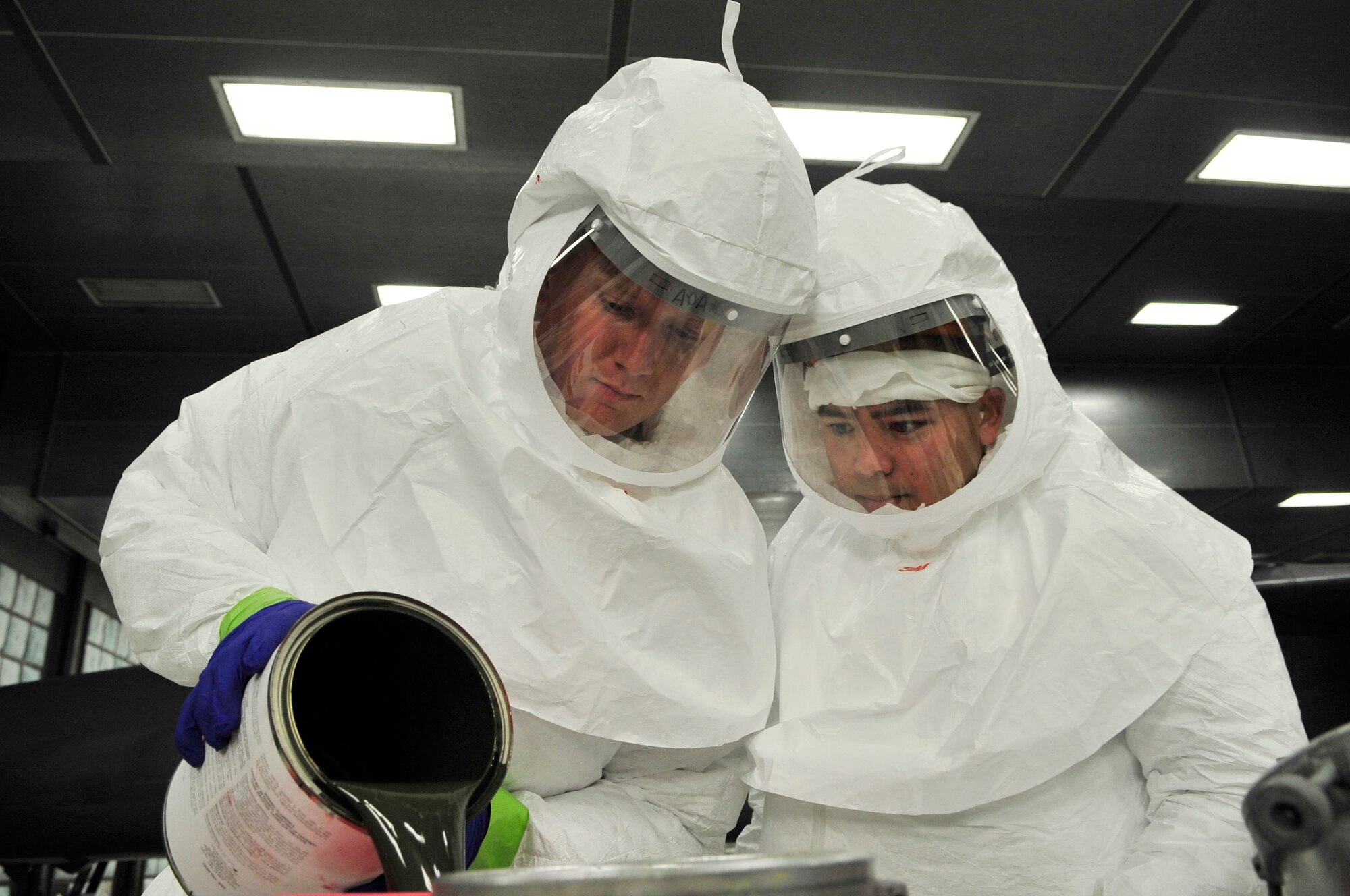 U.S. Air Force Airman 1st Class Zach Sherman, 20th Equipment Maintenance Squadron aircraft structural equipment journeyman,(left), and Staff Sgt. Shon Nguyen, 20th EMS aircraft equipment specialist(right), prepares a paint for the painting of an Aardvark F-111 at Shaw Air Force Base, S.C., July 27, 2012.   The  F-111 was to assigned to the 20th Fighter wing from 1970 to 1993.  It flew on 21 missions during Operation Desert Storm and will now be on display as a static aircraft here at Shaw.(U.S. Air Force photo by Airman Nicole Sikorski/Released) 