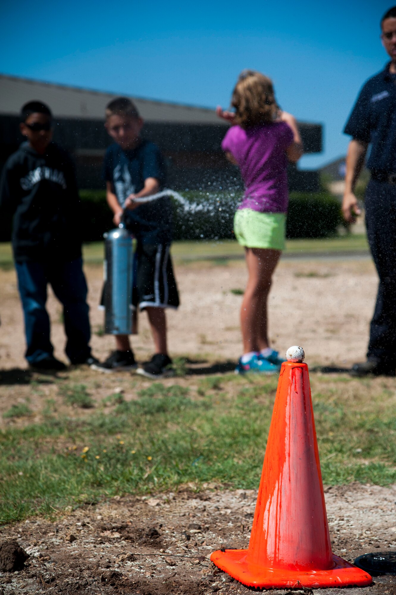 GOODFELLOW AIR FORCE BASE, Texas—Junior Firefighter Camp participants practice how to use a fire extinguisher by hitting a golf ball July 23. The camp gives children the opportunity to learn life saving skills for medical and fire emergencies. (U.S. Air Force photo/Airman 1st Class Michael Smith)