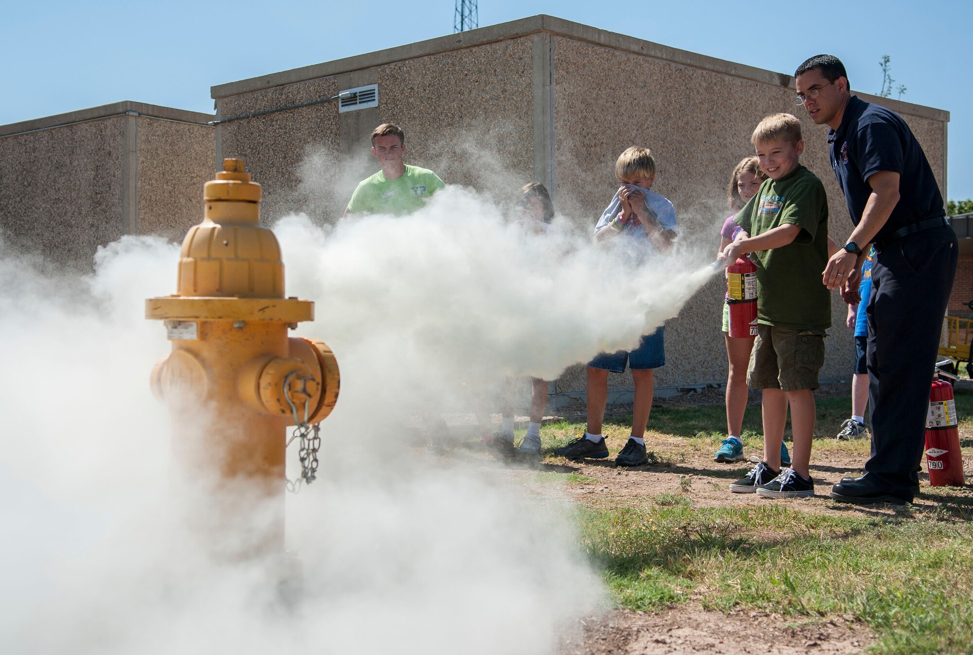 GOODFELLOW AIR FORCE BASE, Texas--Jason Garcia, 17th Civil Engineer Squadron fire inspector, instructs the Junior Firefighter Camp children on how to use a fire extinguisher July 23. The camp gives children the opportunity to learn life saving skills for medical and fire emergencies. (U.S. Air Force photo/Airman 1st Class Michael Smith)