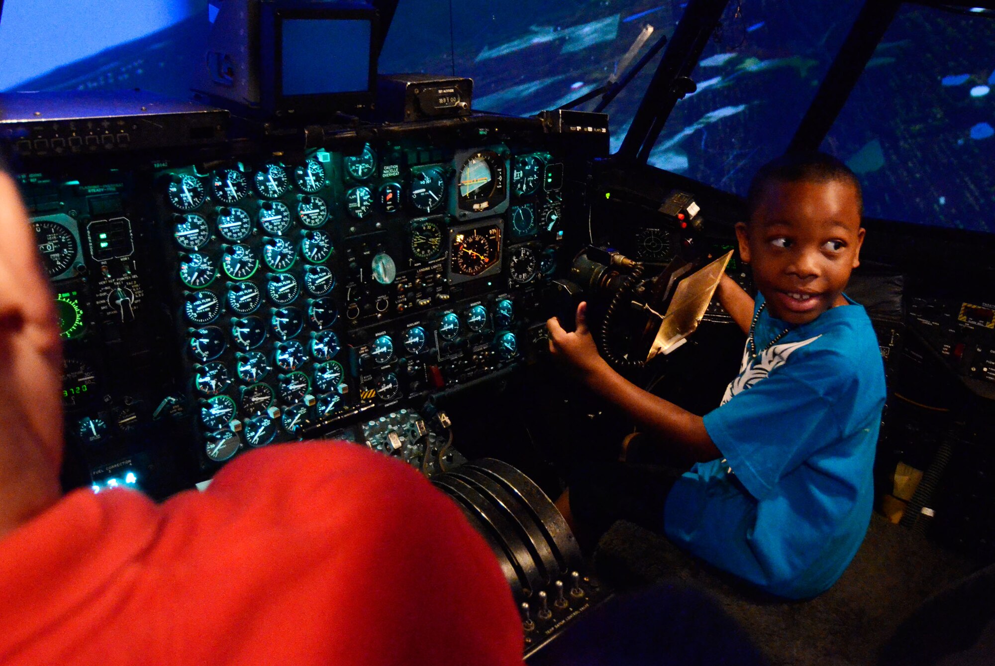 Camden Rubin, son of Technical Sgt. Camille Rubin, of the 94th Communications Squadron, takes his turn in the C-130 flight simulator during the Bring Your Kids to Work Day at Dobbins Air Reserve Base, Ga., July 27. Personnel were able to bring their kids to work centers and then to a hangar for hands-on experience at displays fire department, explosive ordnance and security forces as well as a C-130 simulator demonstration. (U.S. Air Force photo/Don Peek)