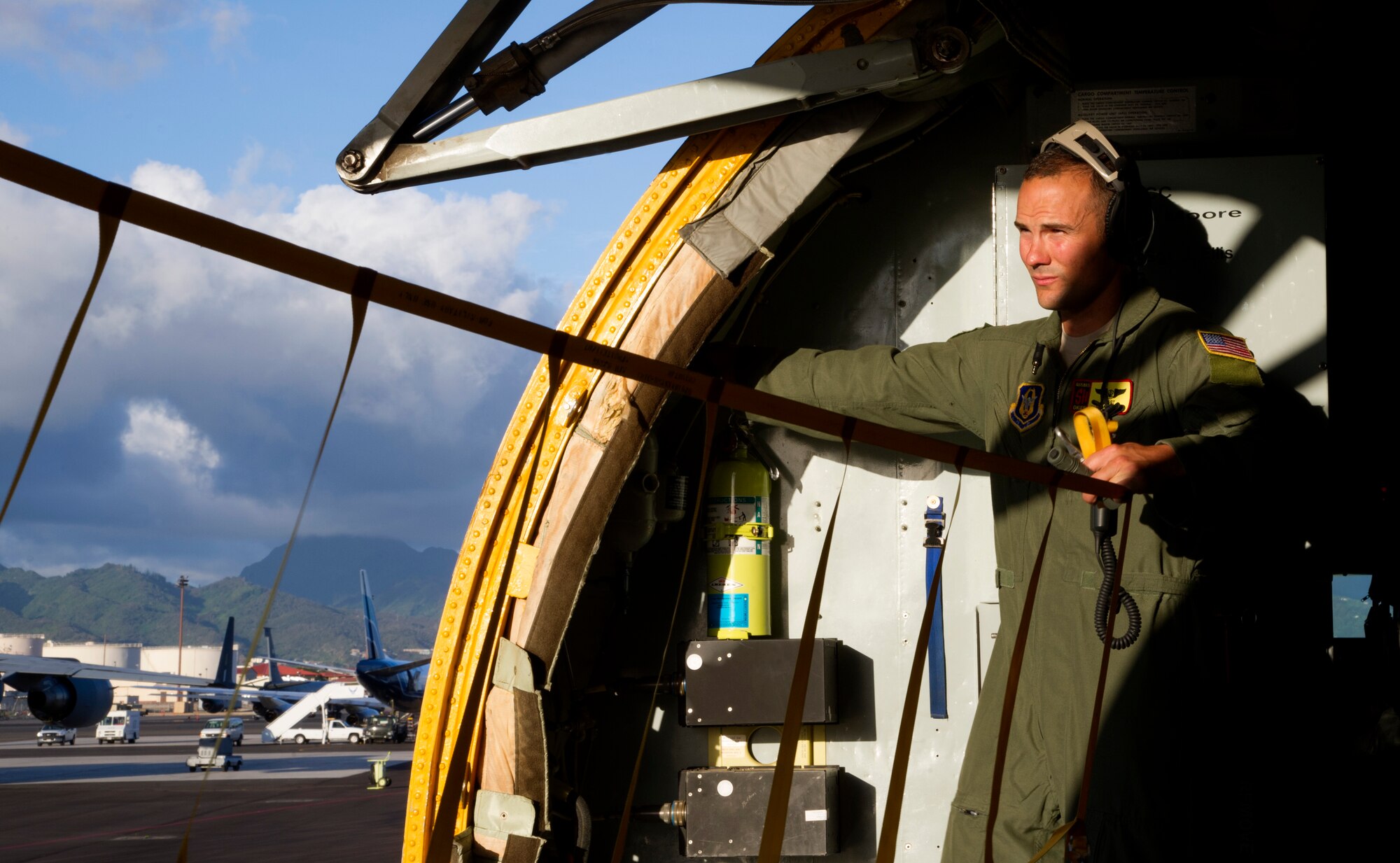 Staff Sgt. Sean Gilson, a boom operator on a KC-135 Stratotanker with the 465th Air Refueling Squadron, Tinker Air Force Base, Okla., lowers the cargo door prior to a mission during Rim of the Pacific exercise, July 23, 2012. Twenty-two nations, more than 40 ships and submarines, more than 200 aircraft and 25,000 personnel are in RIMPAC exercise from June 29 to Aug. 3, in and around the Hawaiian Islands. The world's largest international maritime exercise, RIMPAC provides a unique training opportunity that helps participants foster and sustain the cooperative relationships that are critical to ensuring the safety of sea lanes and security on the world's oceans. RIMPAC 2012 is the 23rd exercise in the series that began in 1971. (U.S. Air Force photo by Tech. Sgt. Bradley C. Church)(Released)
