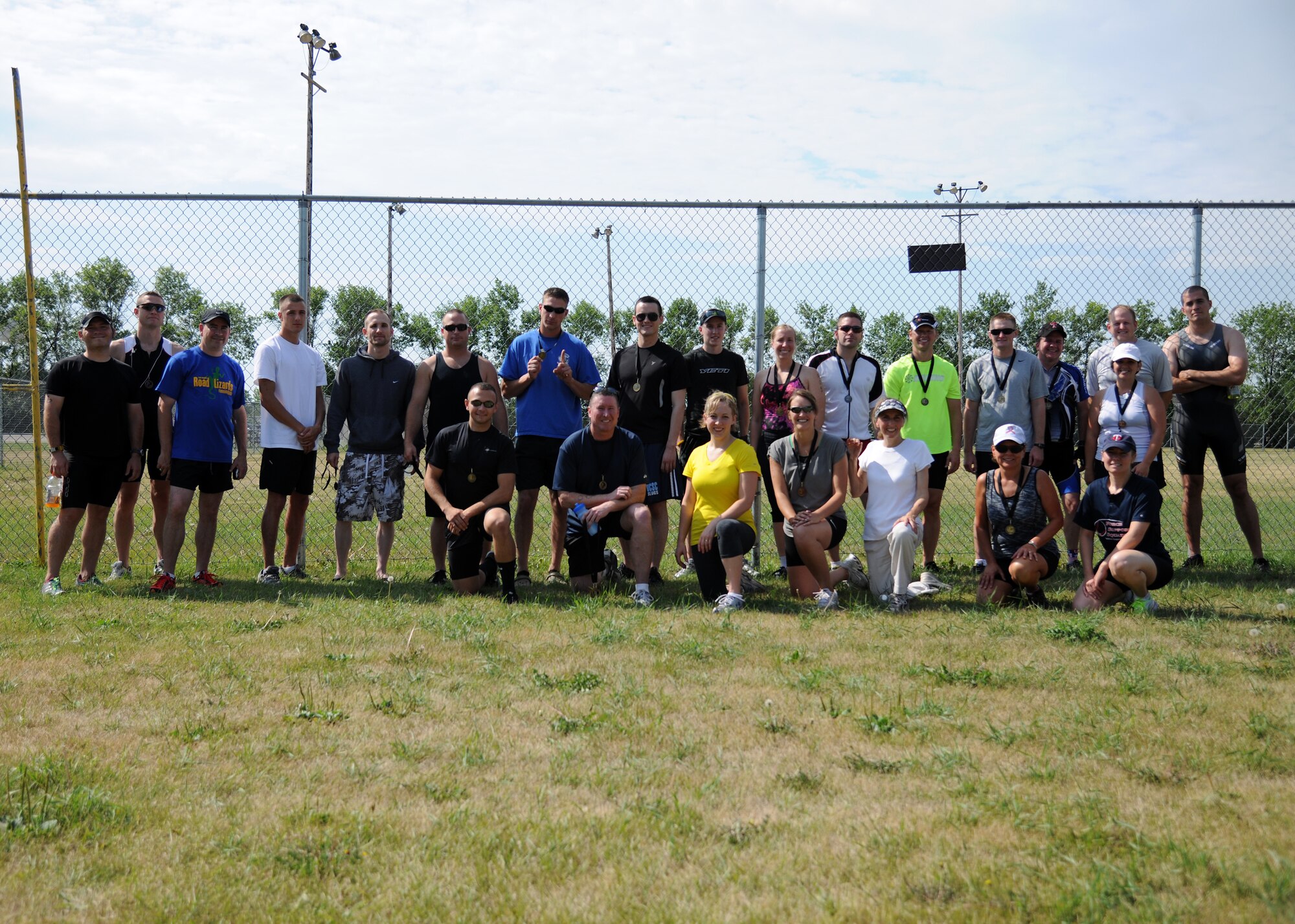 Participants pause for a group photo after completing the 2012 Grand Forks Air Force Base Triathlon on July 28, 2012, on Grand Forks Air Force Base, N.D.  Twenty-one individuals and five teams competed in the event.  (U.S. Air Force photo/Airman 1st Class Ashley N. Taylor)