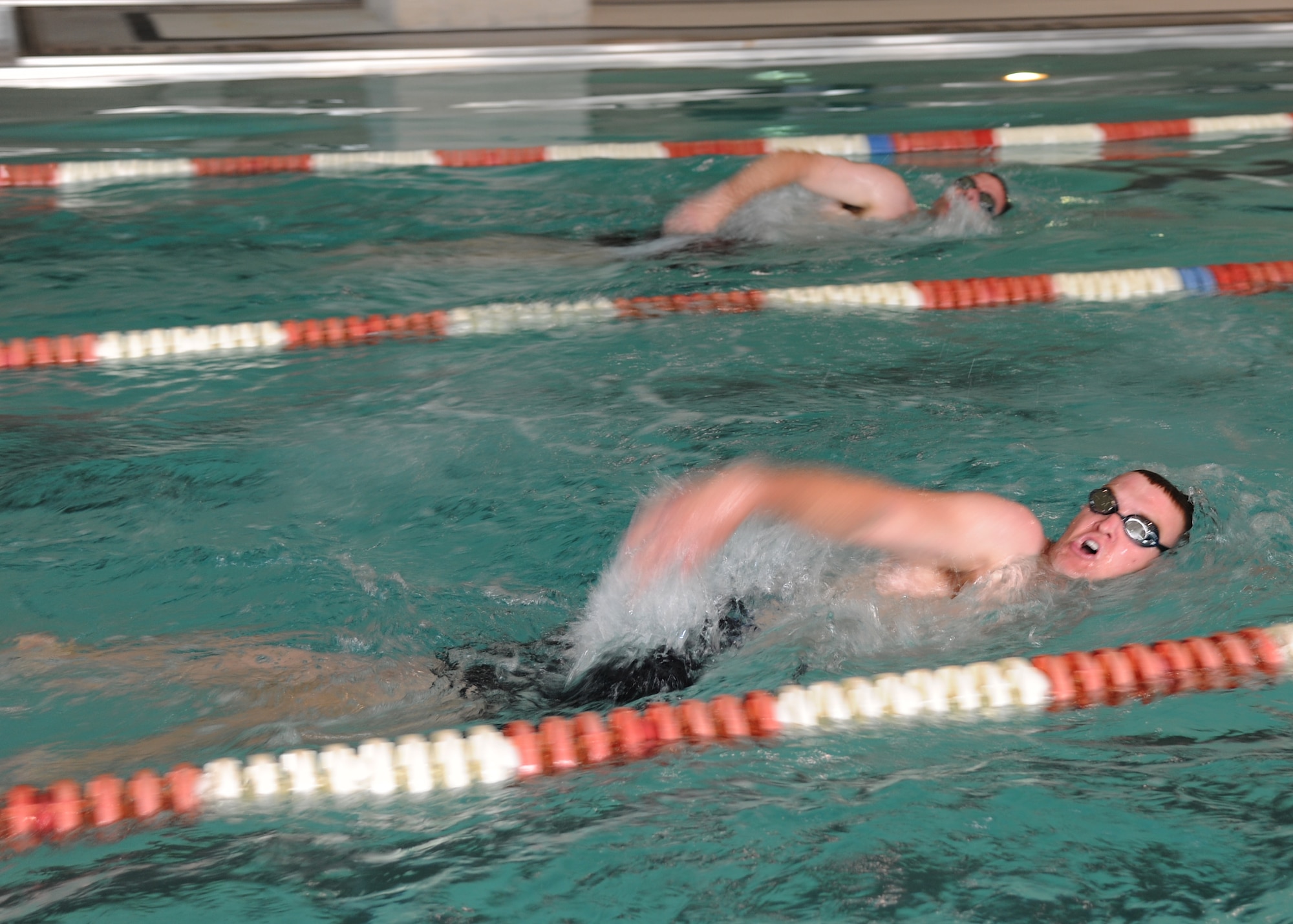 Airman Justin Emanuelson (foreground), 319th Civil Engineer Squadron, competes against Capt. Andrew Stevens, 319th Medical Operations Squadron, during the swimming portion of the 2012 Grand Forks Air Force Base Triathlon on July 28, 2012, on Grand Forks Air Force Base, N.D.  Twenty-one individuals and five teams competed in the event.  (U.S. Air Force photo by Airman 1st Class Ashley N. Taylor)  