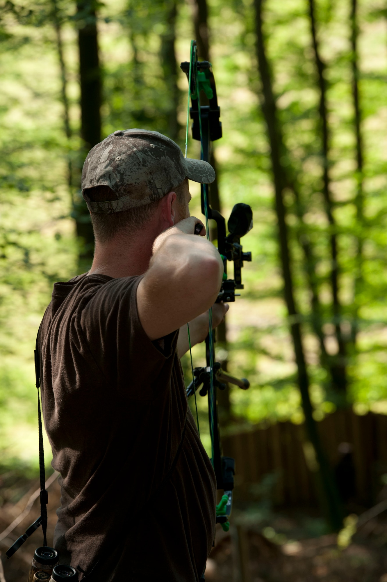 DAHLEM, Germany -- Tech. Sgt. Kevin Phillips, 52nd Equipment Maintenance Squadron aircraft structural maintainer, shoots at fake bear and deer targets on the 3-D archery range at the Eifel Bow Hunting Club July 26 here. Phillips is an amateur archer who is competing to become a professional at the European 5 Nations Field Series tournament in Ash, Luxembourg, this year. He trains with local archers with whom he builds partnerships through exchanging archery techniques. (U.S. Air Force photo by Senior Airman Natasha Stannard/Released)