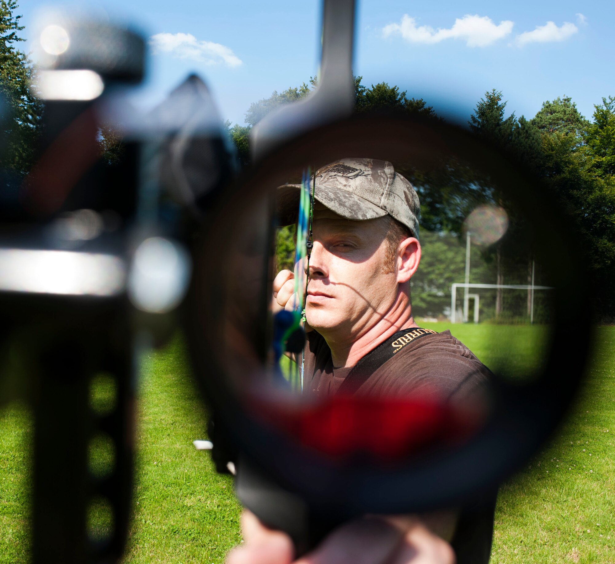 DAHLEM, Germany -- Tech. Sgt. Kevin Phillips, 52nd Equipment Maintenance Squadron aircraft structural maintainer, practices using his sight to find the center of a target at the Eifel Bow Hunting Club July 26 here. Phillips is an amateur archer who is competing to become a professional at the European 5 Nations Field Series tournament in Ash, Luxembourg, this year. He trains with local archers with whom he builds partnerships through exchanging archery techniques. (U.S.  Air Force photo by Senior Airman Natasha Stannard/Released)