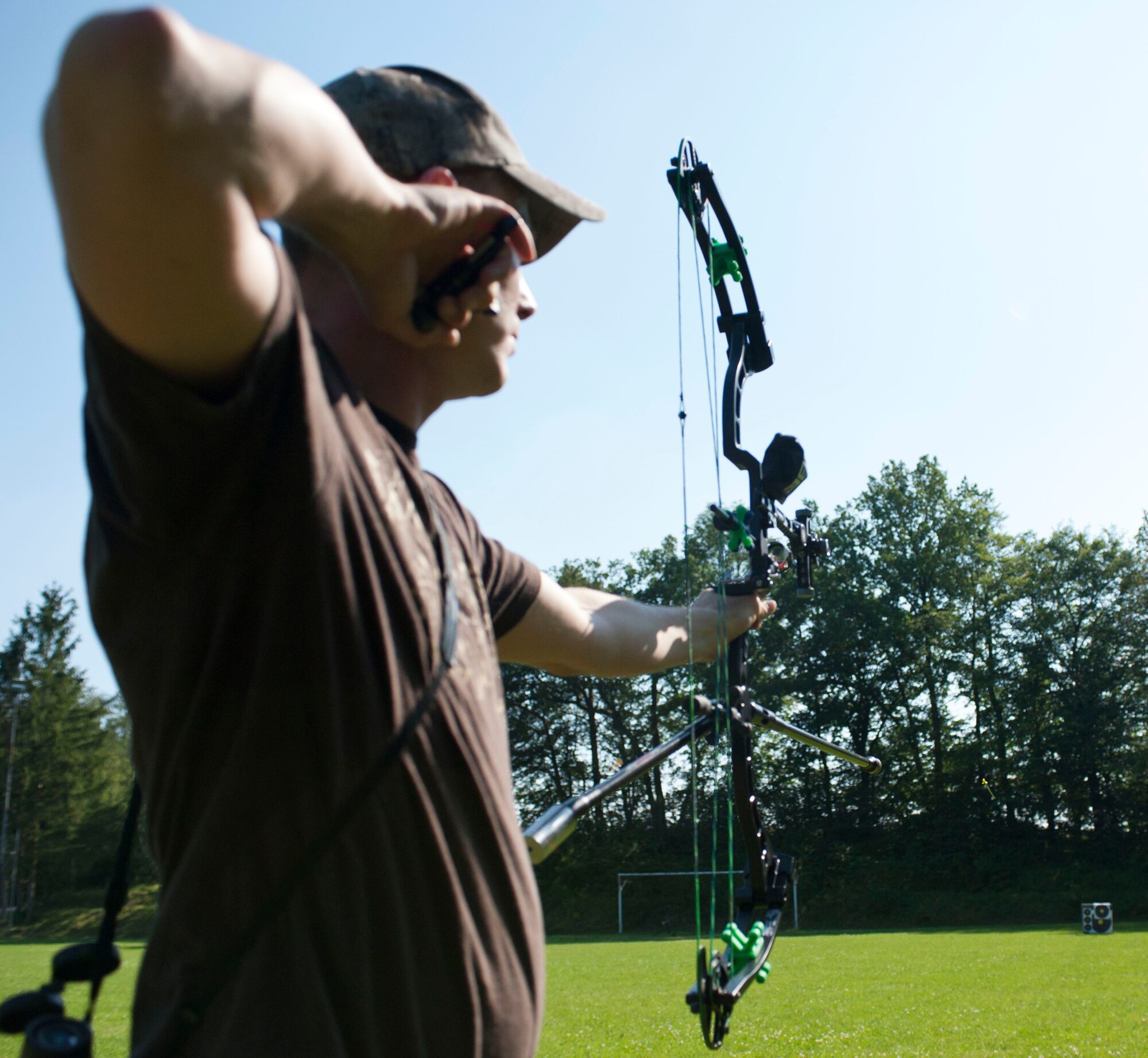 DAHLEM, Germany -- Tech. Sgt. Kevin Phillips, 52nd Equipment Maintenance Squadron aircraft structural maintainer, releases an arrow during archery practice at the Eifel Bow Hunting Club July 26 here. Phillips is an amateur archer who is competing to become a professional at the European 5 Nations Field Series tournament in Ash, Luxembourg, this year. He trains with local archers with whom he builds partnerships through exchanging archery techniques. (U.S.  Air Force photo by Senior Airman Natasha Stannard/Released)
