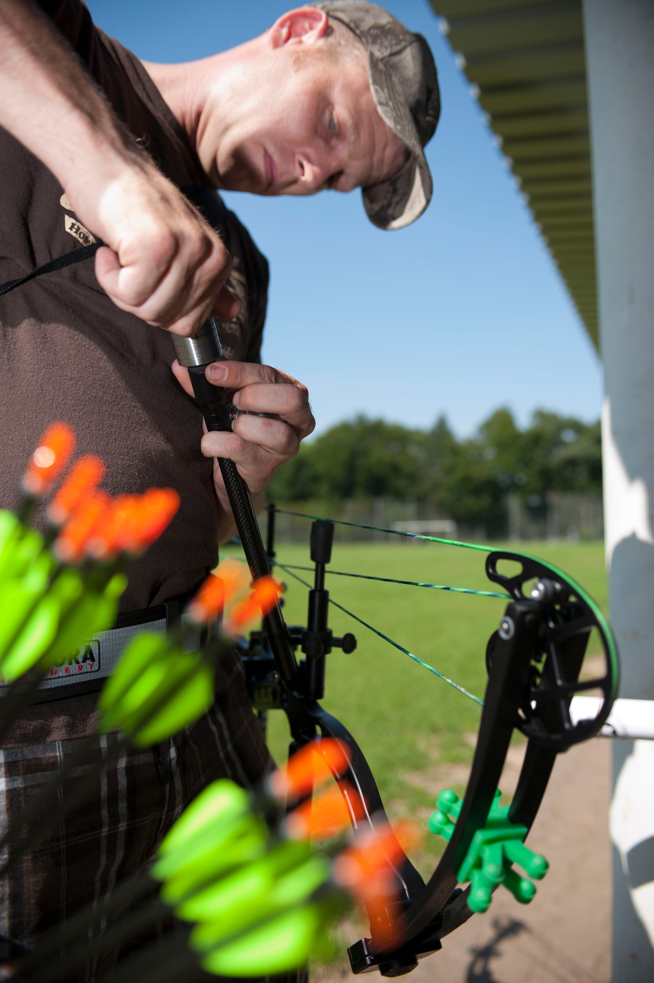 DAHLEM, Germany -- Tech. Sgt. Kevin Phillips, 52nd Equipment Maintenance Squadron aircraft structural maintainer, sets up his gear before archery practice at the Eifel Bow Hunting Club July 26 here. Phillips is an amateur archer who is competing to become a professional at the European 5 Nations field tournament in Ash, Luxembourg, this year. He trains with local archers with whom he builds partnerships through exchanging archery techniques. (U.S.  Air Force photo by Senior Airman Natasha Stannard/Released)