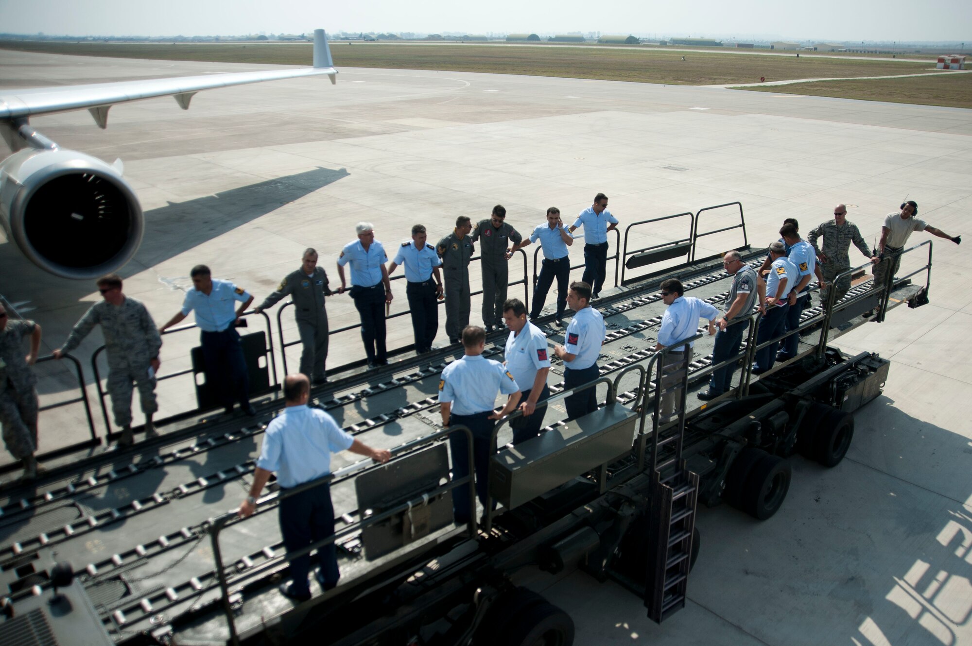 Members of the Turkish air force prepare to enter an aircraft during a site visit July 25, 2012, at Incirlik Air Base, Turkey. The 728th Air Mobility Squadron hosted the visit to help members of the Turkish air force 11th Tanker Command enhance their aerial port operations. (U.S. Air Force photo by Senior Airman Clayton Lenhardt/Released)