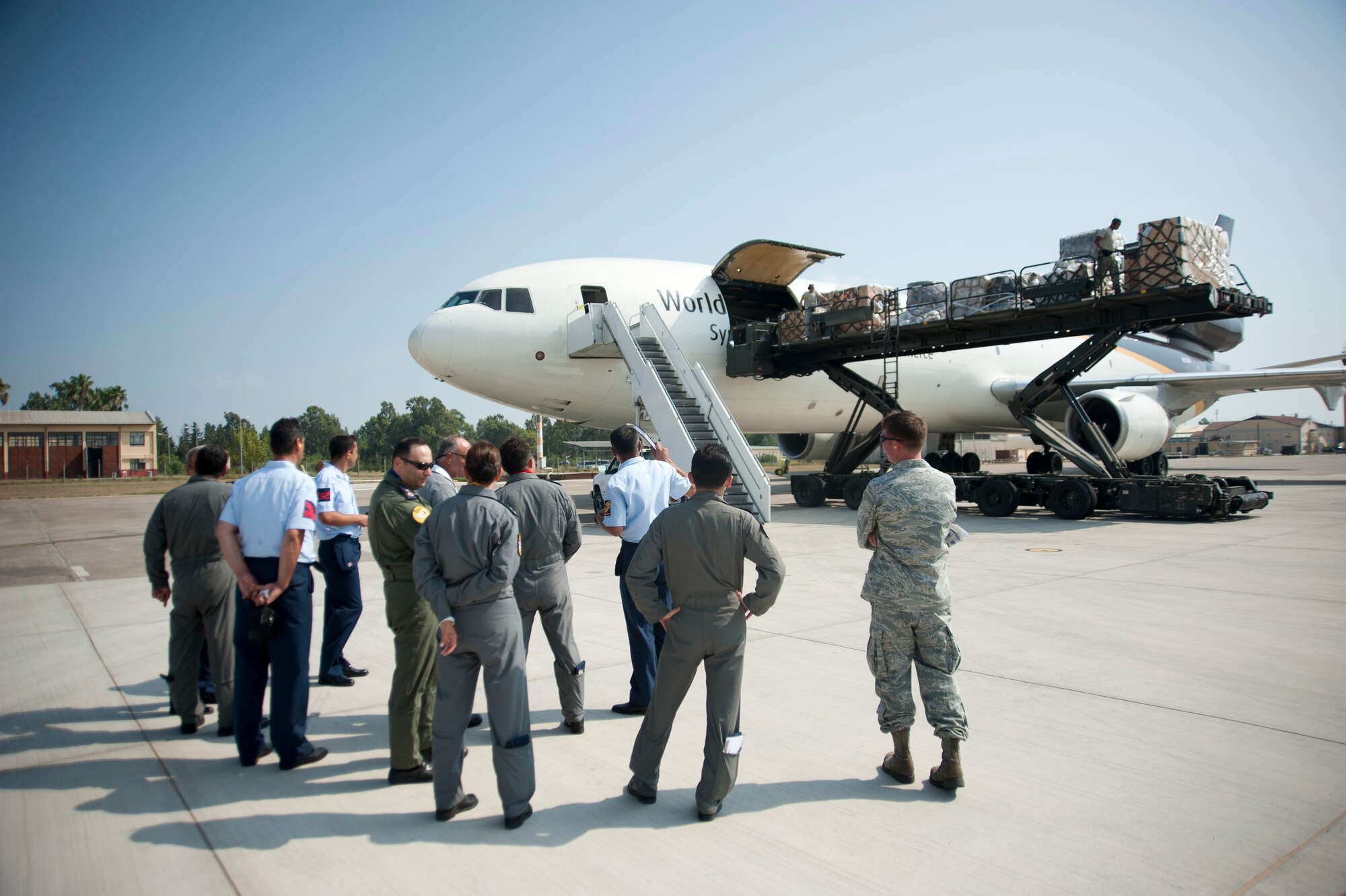 Members of the Turkish air force observe cargo downloading during a site visit July 25, 2012, at Incirlik Air Base, Turkey. The 728th Air Mobility Squadron hosted the visit to help members of the Turkish air force 11th Tanker Command enhance their aerial port operations. (U.S. Air Force photo by Senior Airman Clayton Lenhardt/Released)