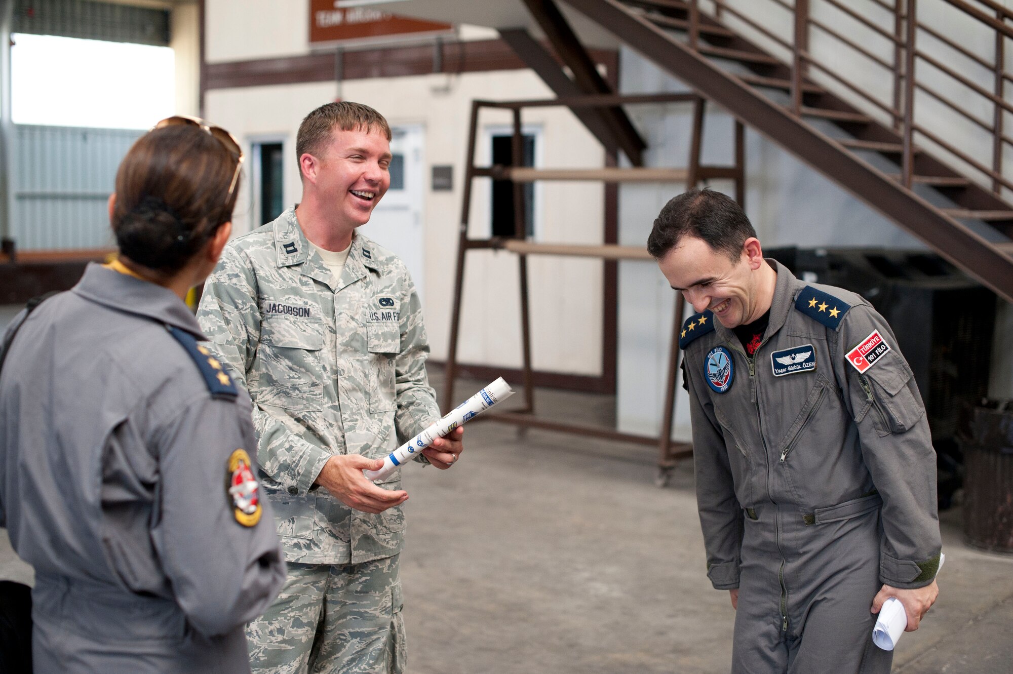 Capt. Christopher Jacobson, 728th Air Mobility Squadron, shares a joke with members of the Turkish air force during a site visit July 25, 2012, at Incirlik Air Base, Turkey. The 728th AMS hosted the visit to help members of the Turkish air force 11th Tanker Command enhance their aerial port operations. (U.S. Air Force photo by Senior Airman Clayton Lenhardt/Released)