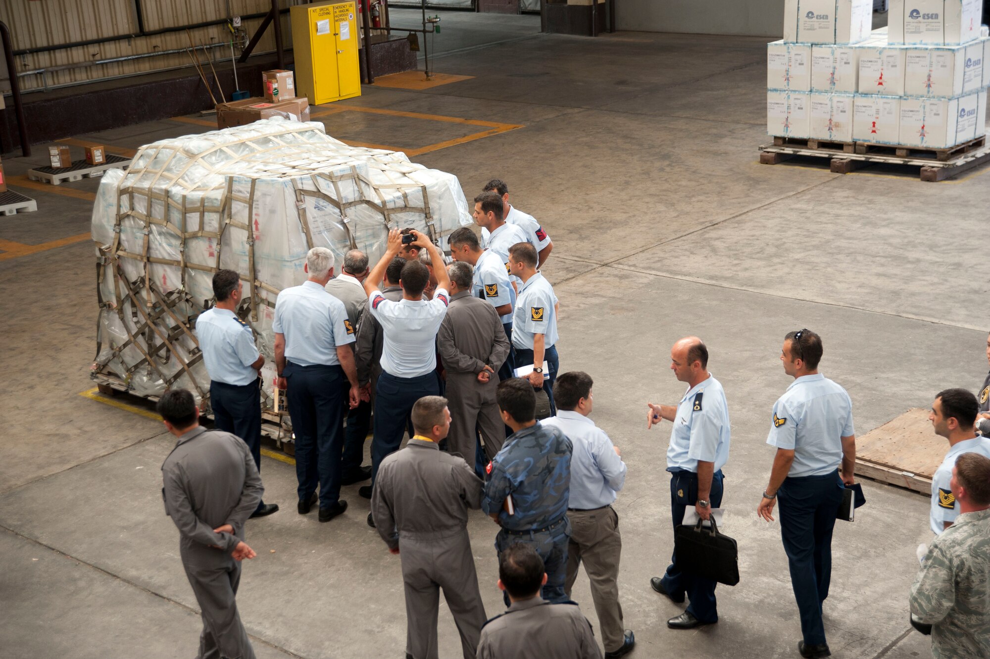 Members of the Turkish air force tour a cargo warehouse during a site visit July 25, 2012, at Incirlik Air Base, Turkey. The 728th Air Mobility Squadron hosted the visit to help members of the Turkish air force 11th Tanker Command enhance their aerial port operations. (U.S. Air Force photo by Senior Airman Clayton Lenhardt/Released)