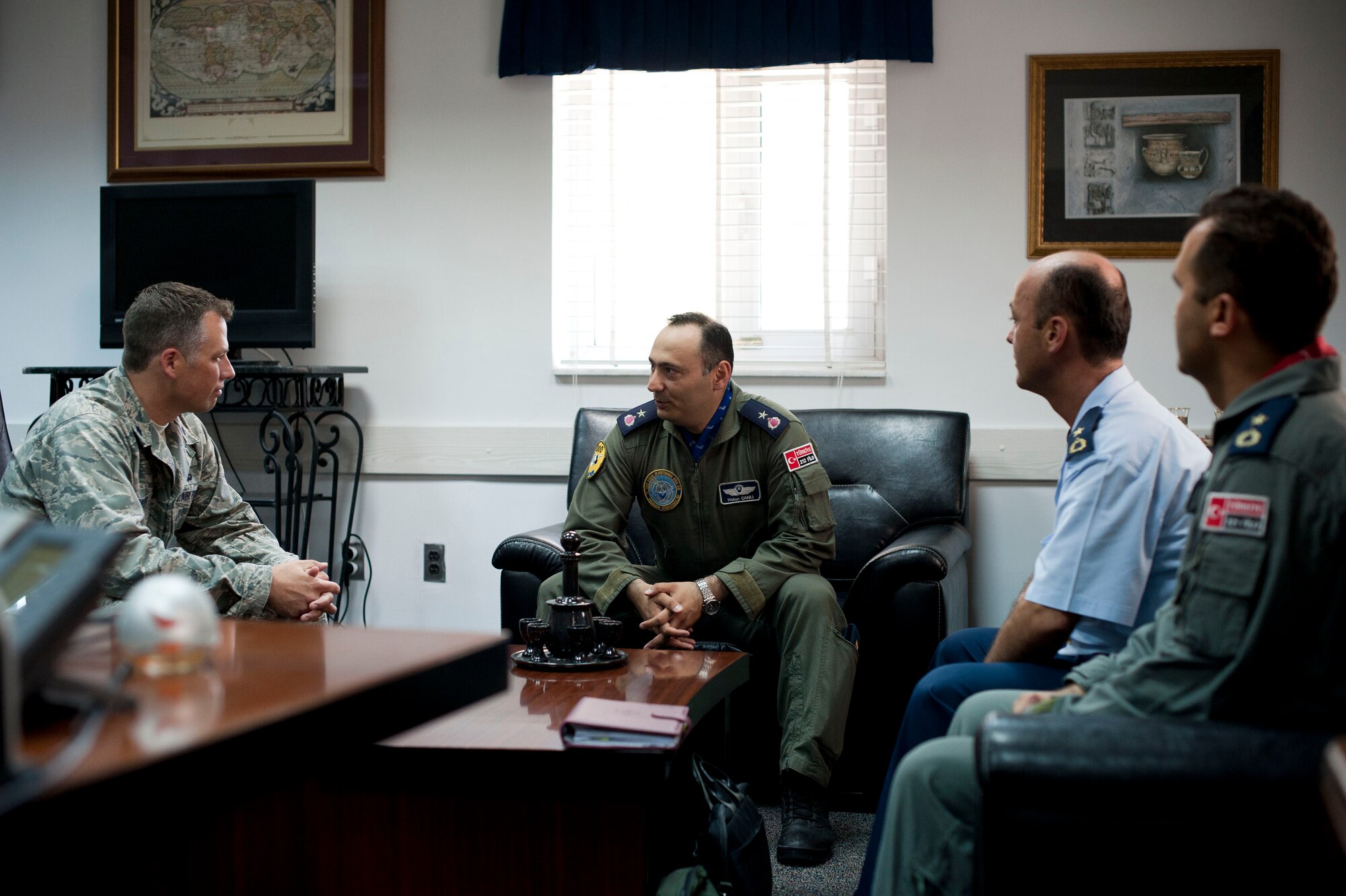 Lt. Col. Henry Triplett III, 728th Air Mobility Squadron commander, speaks with Turkish air force officers during a site visit July 25, 2012, at Incirlik Air Base, Turkey. The 728th AMS hosted the visit to help members of the Turkish air force 11th Tanker Command enhance their aerial port operations. (U.S. Air Force photo by Senior Airman Clayton Lenhardt/Released)