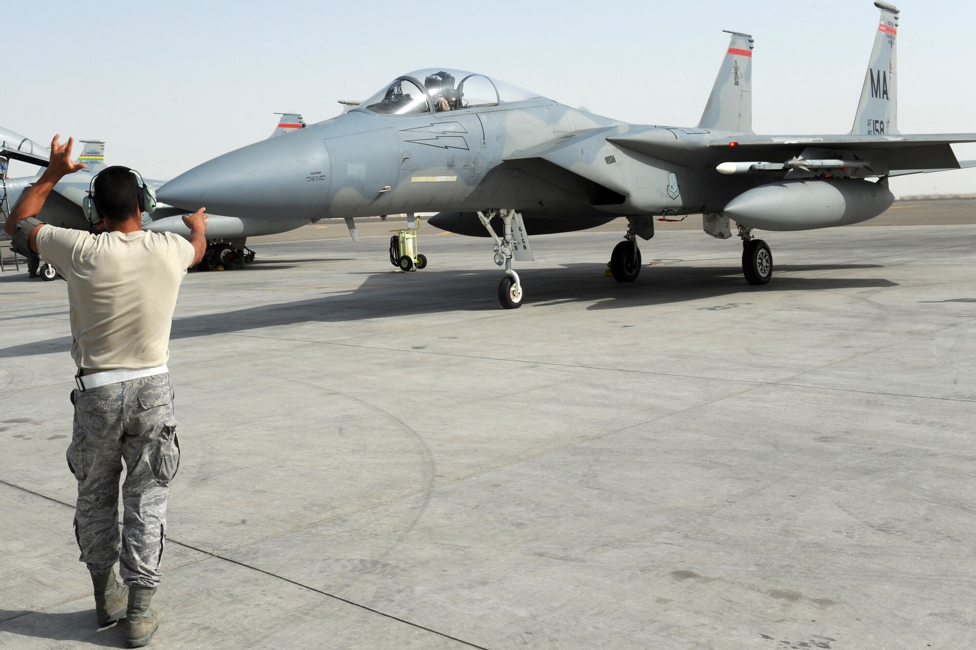 SOUTHWEST ASIA - U.S. Air Force Staff Sgt. Pedro Acevedo, 380th Expeditionary Aircraft Maintenance Squadron crew chief, marshals Capt. Jeffrey Yeates, 123rd Fighter Squadron pilot, before takeoff July 30, 2012. Acevedo is a member of the Louisiana Air National Guard. Yeates, a Vancouver, Wash., native, is a member of the Oregon Air National Guard and is deployed in support of the 122nd Expeditionary Fighter Squadron. (U.S. Air Force photo/Master Sgt. Scott MacKay)