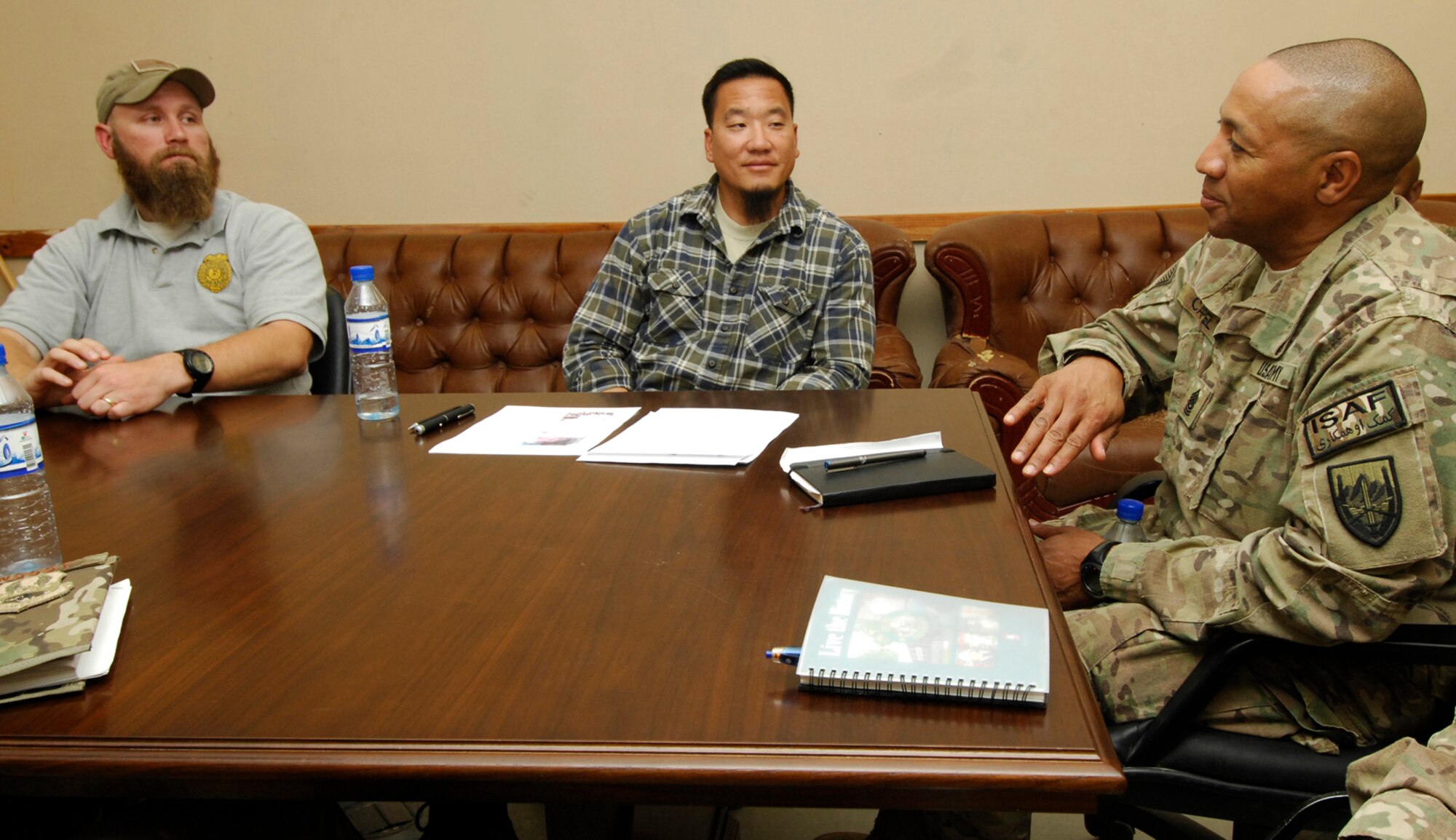 Command Sgt. Maj. Thomas Capel (right), International Security Assistance Force senior enlisted advisor, speaks with agents of the U.S. Air Force Office of Special Investigations detachment during his visit to Bagram Airfield, Afghanistan, July 27, 2012. Capel spoke to Airmen about future operations and thanked them for their contributions in support of ongoing missions in Afghanistan. (U.S. Air Force photo/SSgt Jeff Nevison)