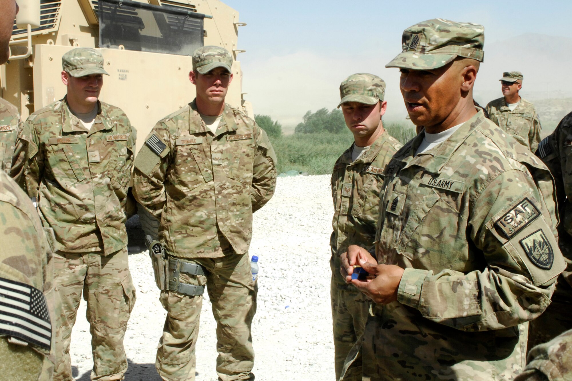 Command Sgt. Maj. Thomas Capel (right), International Security Assistance Force senior enlisted advisor, “coins” various Airmen of the 455th Expeditionary Security Forces Squadron for their outstanding achievements during his visit to Bagram Airfield, Afghanistan, July 27, 2012. Capel spoke to Airmen about future operations and thanked them for their contributions in support of ongoing missions in Afghanistan. (U.S. Air Force photo/SSgt Jeff Nevison)