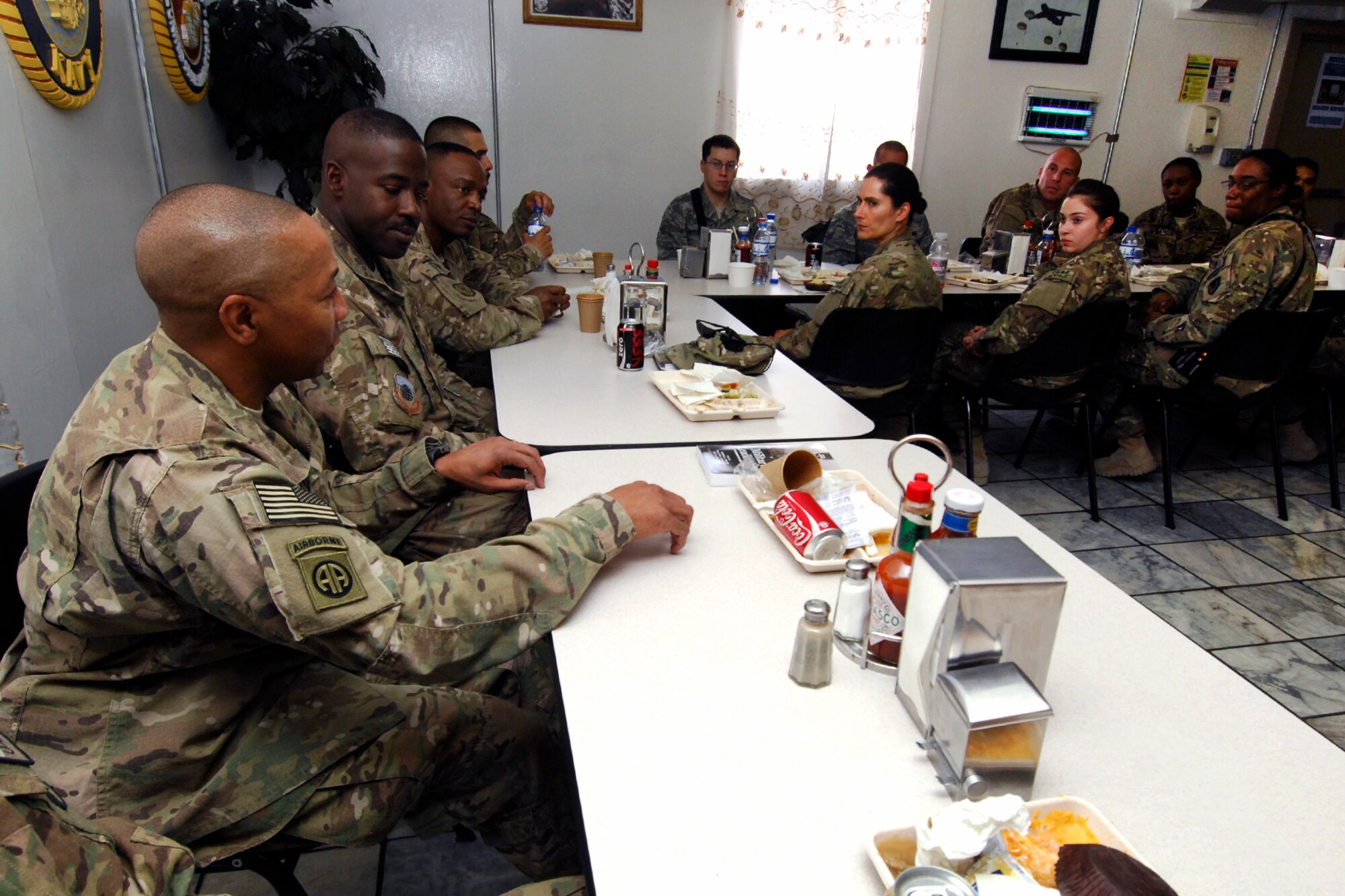 Command Sgt. Maj. Thomas Capel (left), International Security Assistance Force senior enlisted advisor,
converses with United States Soldiers and Airmen at a luncheon during his visit to Bagram
Airfield, Afghanistan, July 27, 2012. Capel spoke to Airmen and Soldiers about future operations and thanked them for their contributions in support of ongoing missions in Afghanistan. (U.S. Air Force photo/SSgt Jeff Nevison)
