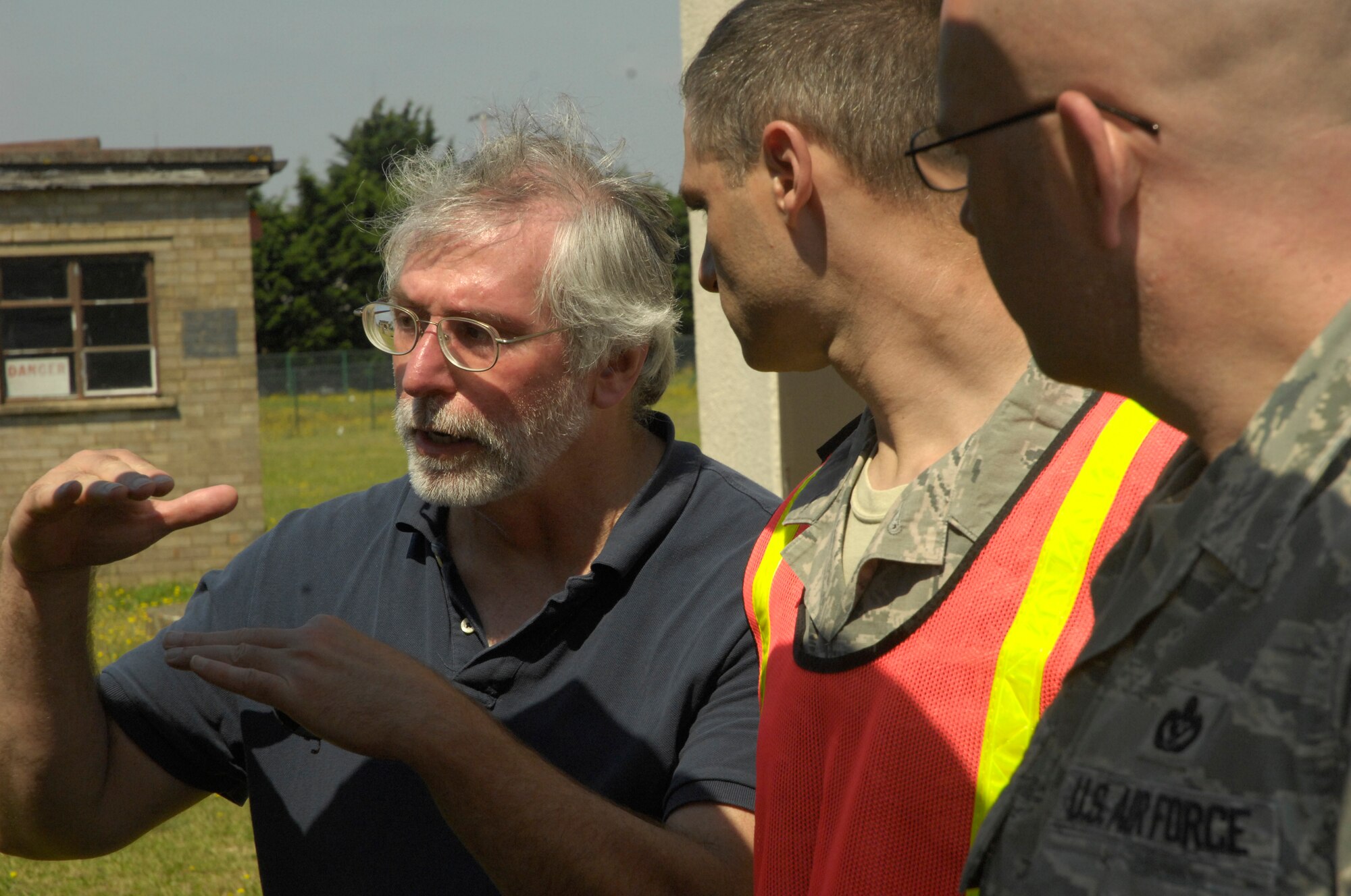 ROYAL AIR FORCE LAKENHEATH, England - (right to left) Senior Master Sgt. Rejean Plante, 48th Civil Engineer Squadron deputy fire chief and Master Sgt. Daniel Parker, 48th CES assistant chief of operations and on-scene commander, listen to David Birney, 48th CES environmental engineer, as he goes over hazardous material containment procedures here July 26, 2012. The 48th CES responded to a HAZMAT incident after several large batteries were found cracked and leaking acid. (U.S. Air Force photo by Tech. Sgt. Zachary Melin)